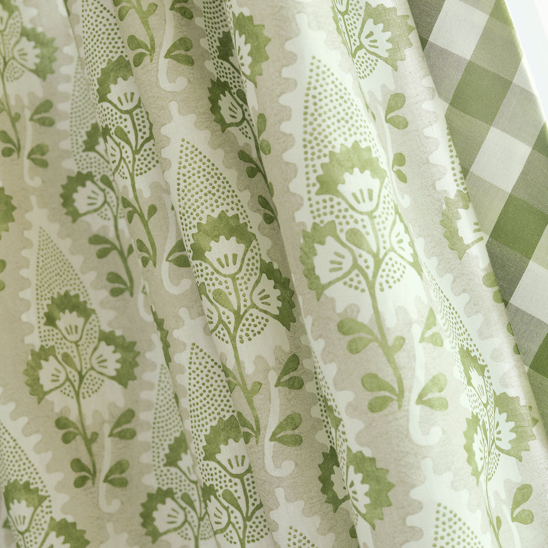 Detail of draperies in Cornwall printed fabric in Green and Beige - pattern number AF15121 - by Anna French in the Antilles collection