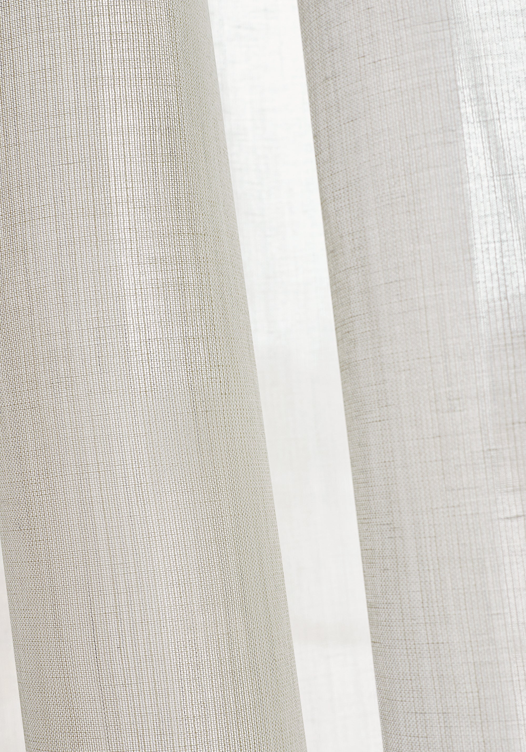 Closeup of sheer drapery curtains made with Thibaut Berkshire woven fabric in Ivory color pattern FWW7118