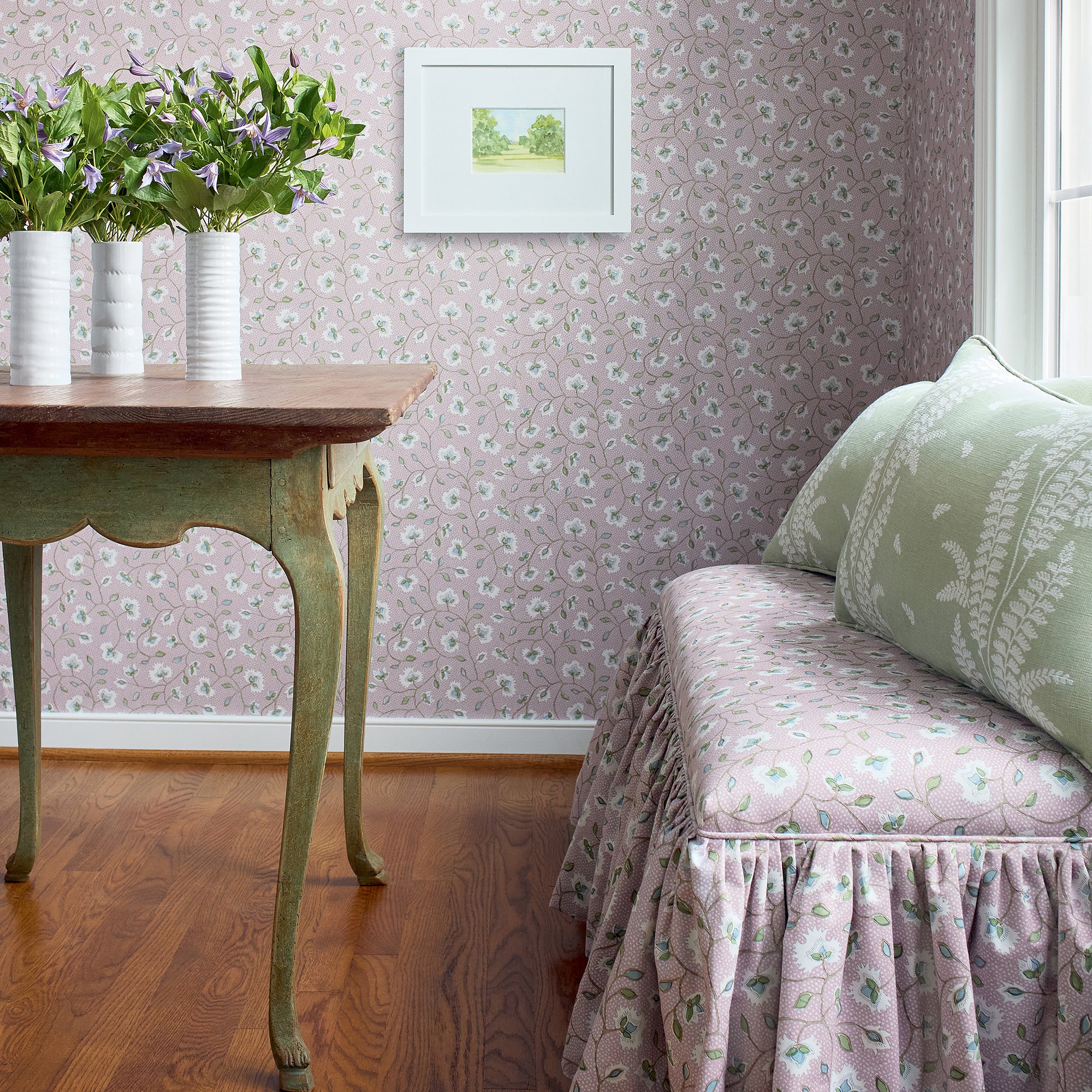 Detailed view of Addison Ottoman with skirt in Chelsea printed fabric in lavender color variant by Anna French in the Bristol collection - pattern number AF57840