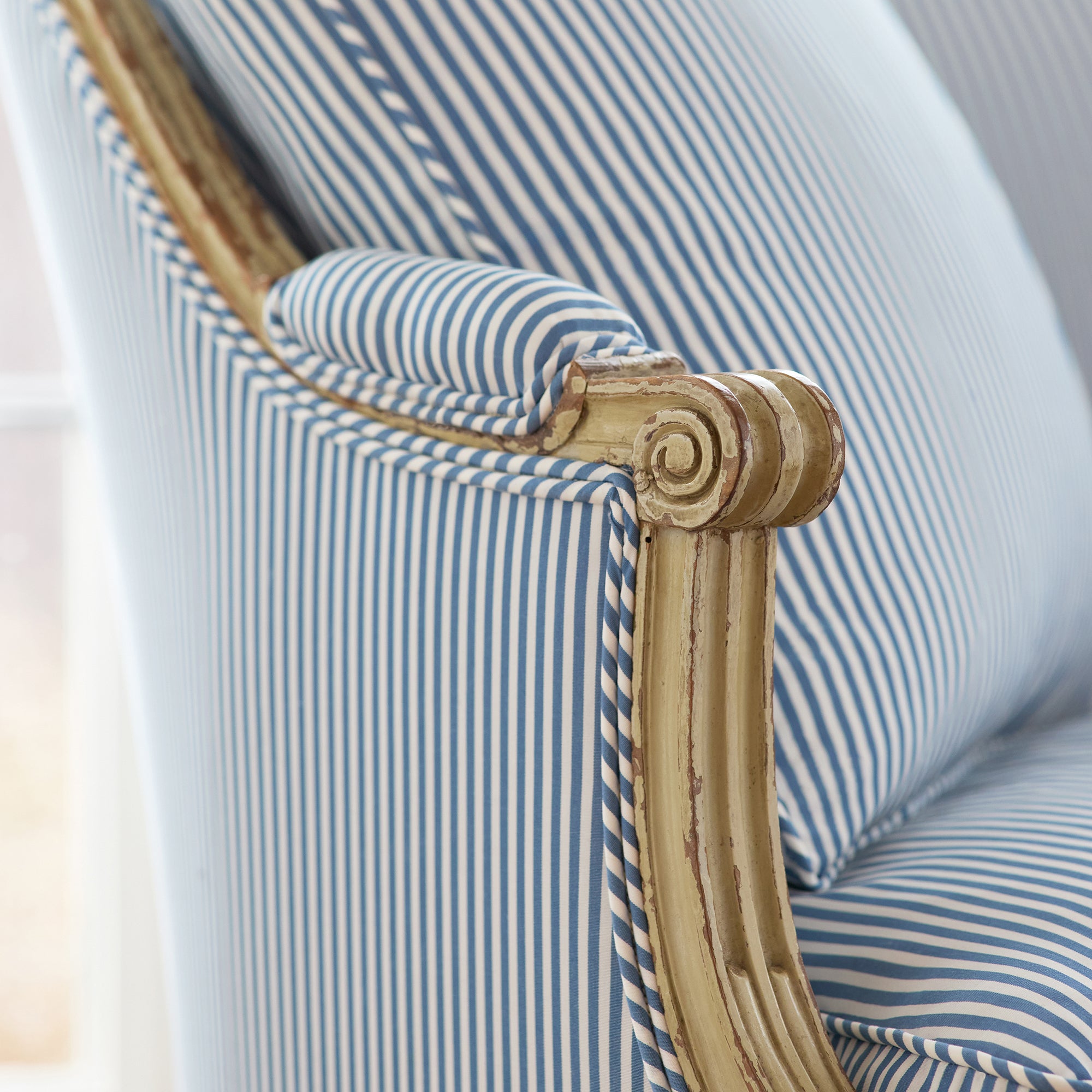 Detailed view of chair in Holden Stripe woven fabric in navy color variant by Anna French in the Bristol collection - pattern number AW57806
