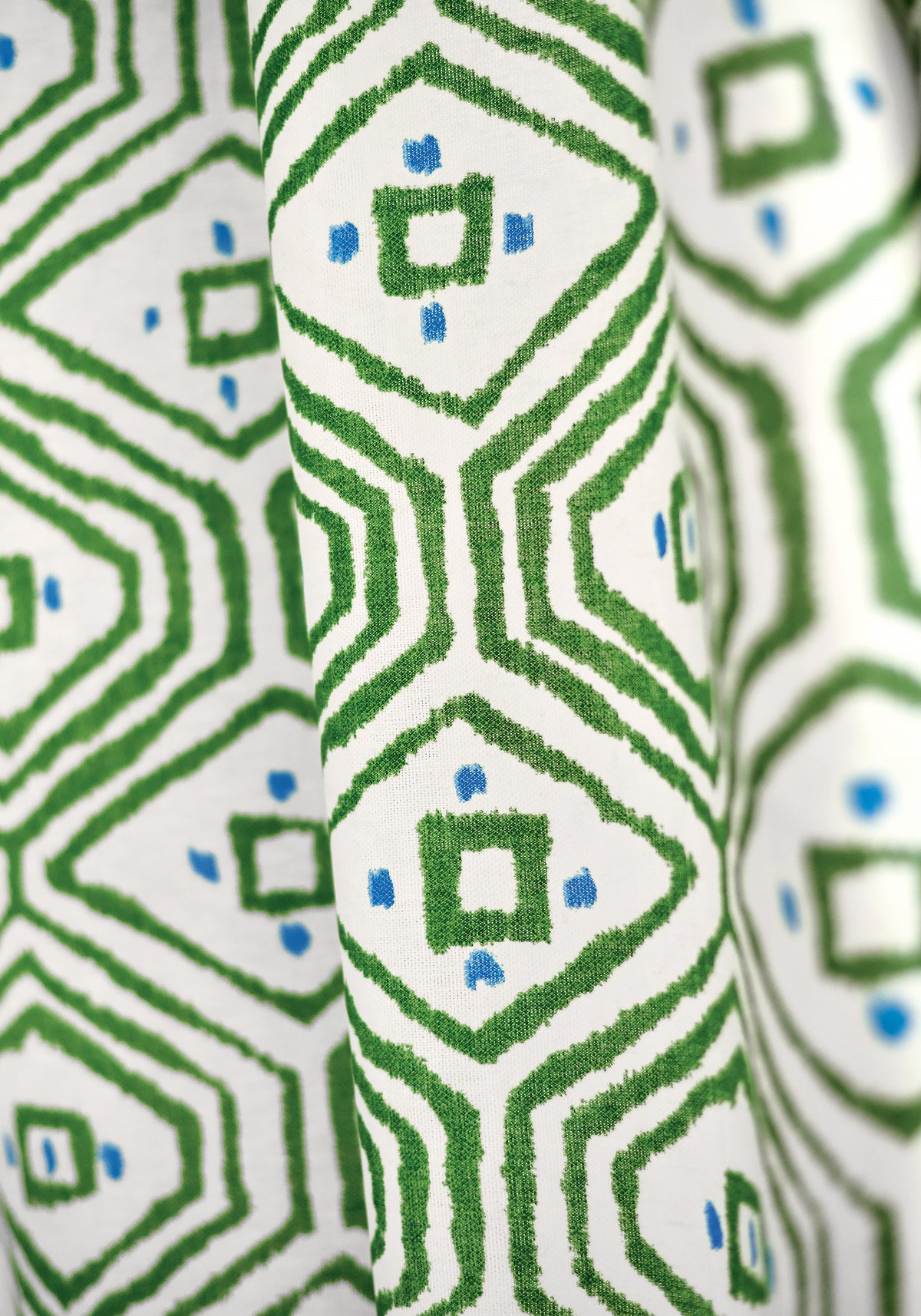 Detail closeup of drapery curtains made with Thibaut Pass-A-Grille fabric in green color - pattern F910616