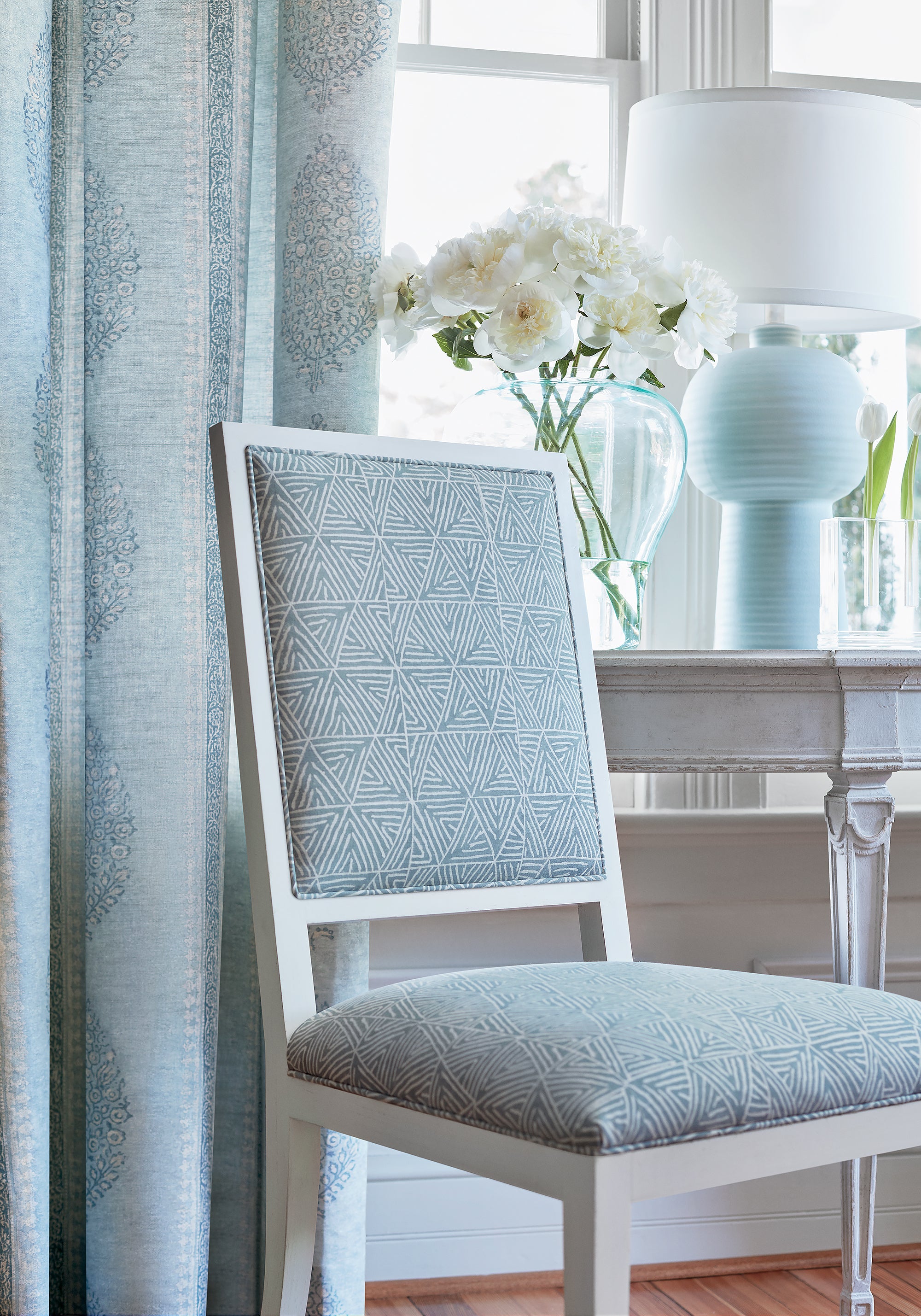 Detailed view of Lauderdale chairs in Mombasa printed fabric in slate blue color variant by Thibaut in the Colony collection - pattern number F910207