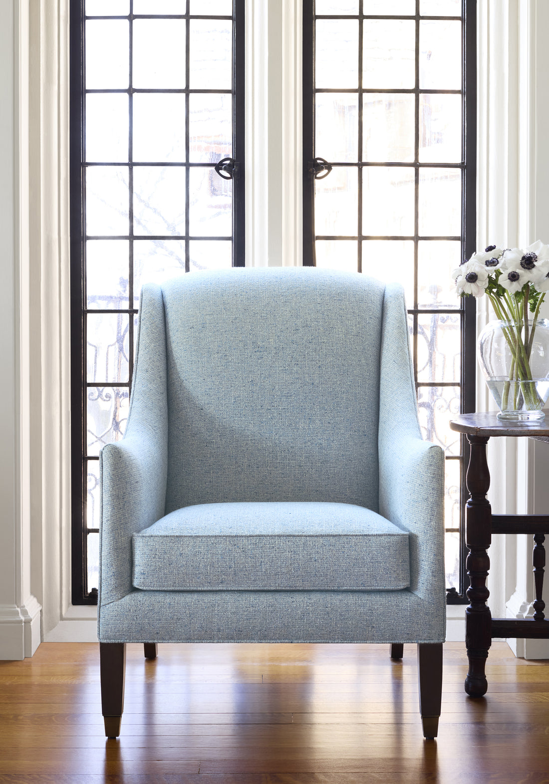Living room with Shelton Wing Chair upholstered in Shannon woven fabric in Waterfall color - pattern number W80932 - by Thibaut fabrics