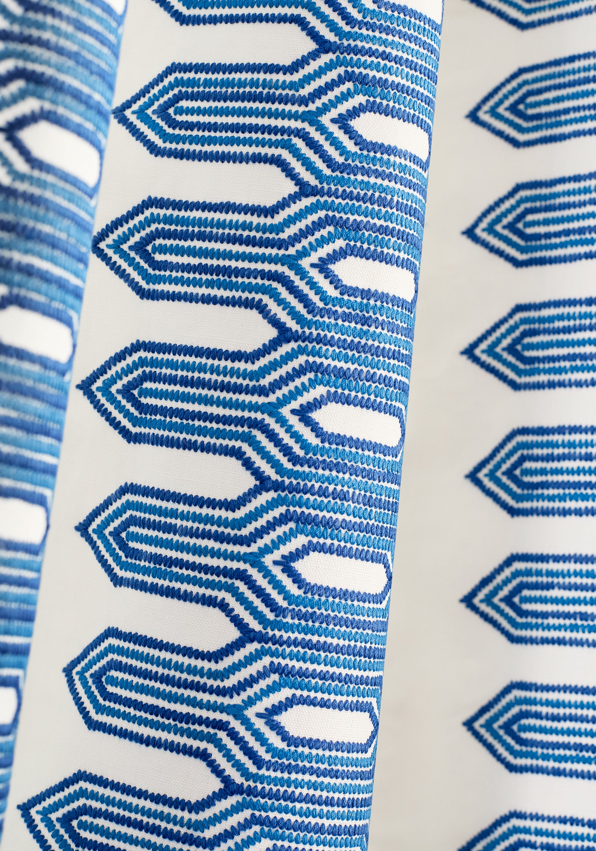 Detailed view of draperies in Nola Stripe Embroidery woven fabric in navy color variant by Thibaut in the Eden collection - pattern number W720810
