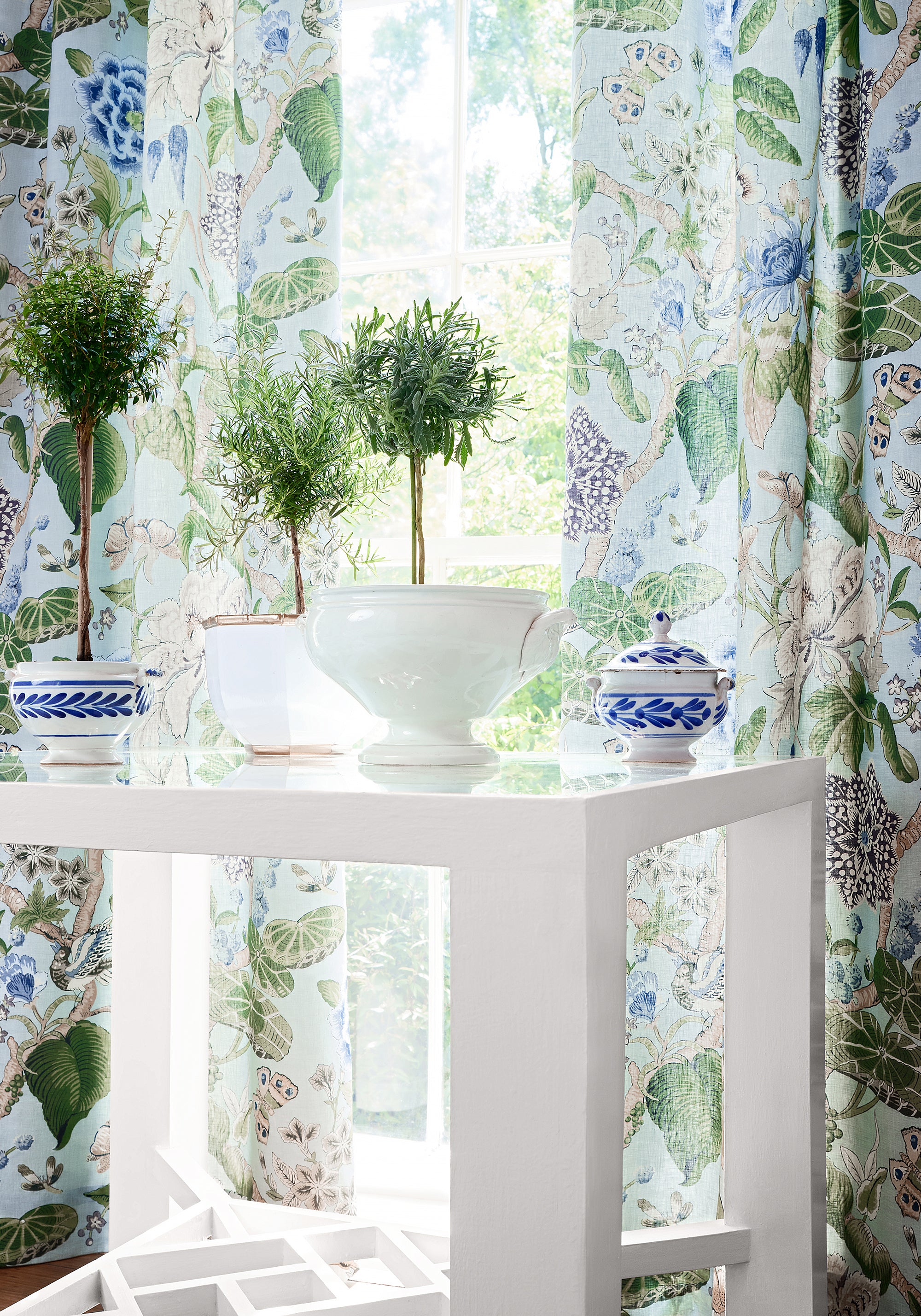 Spa blue color variant of Hill Garden printed fabric draperies, pattern number F913654 of the Thibaut Grand Palace collection