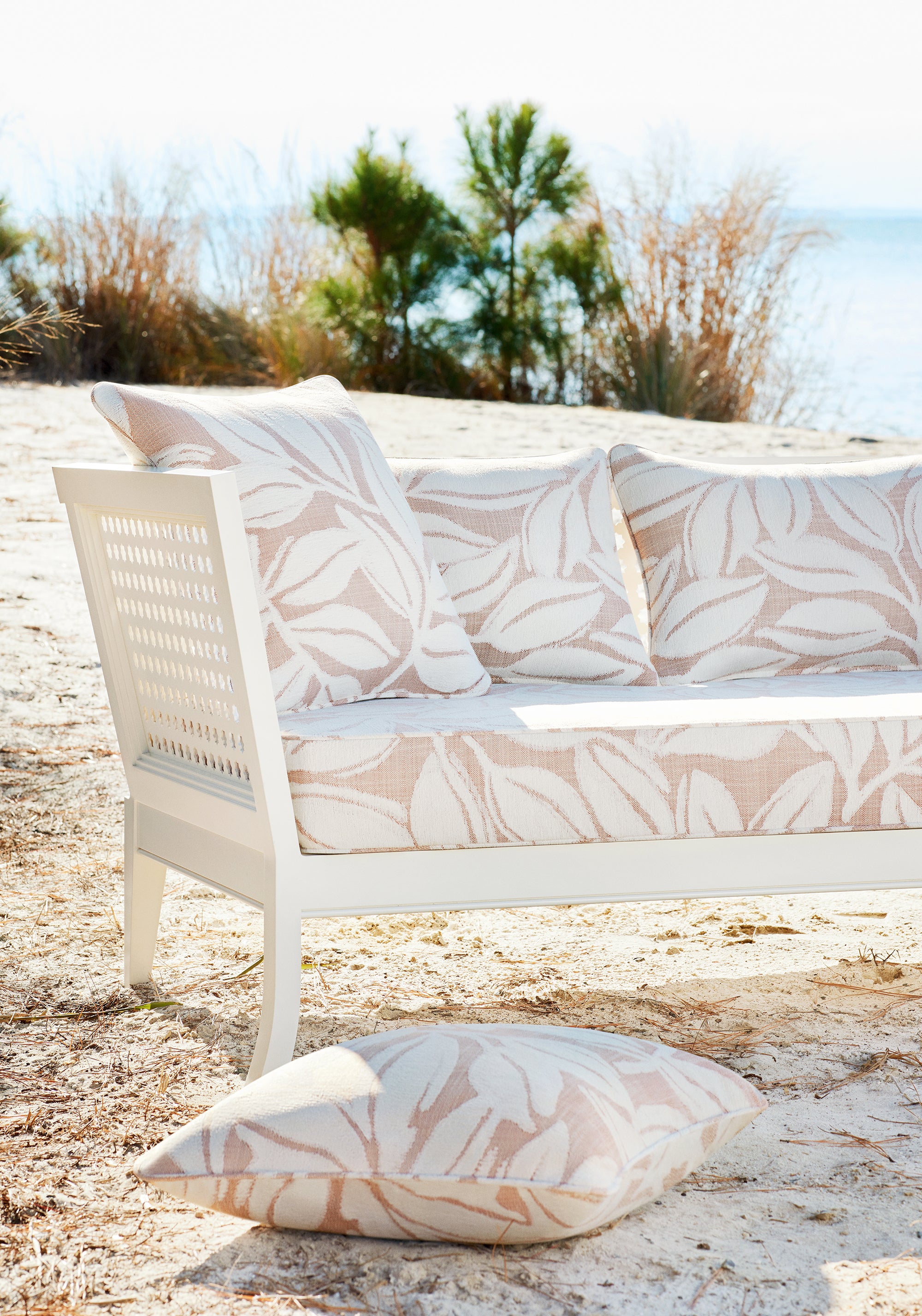 Outdoor pillows and sofa featuring Kona fabric in clay color - pattern number W8810 - by Thibaut in the Haven collection