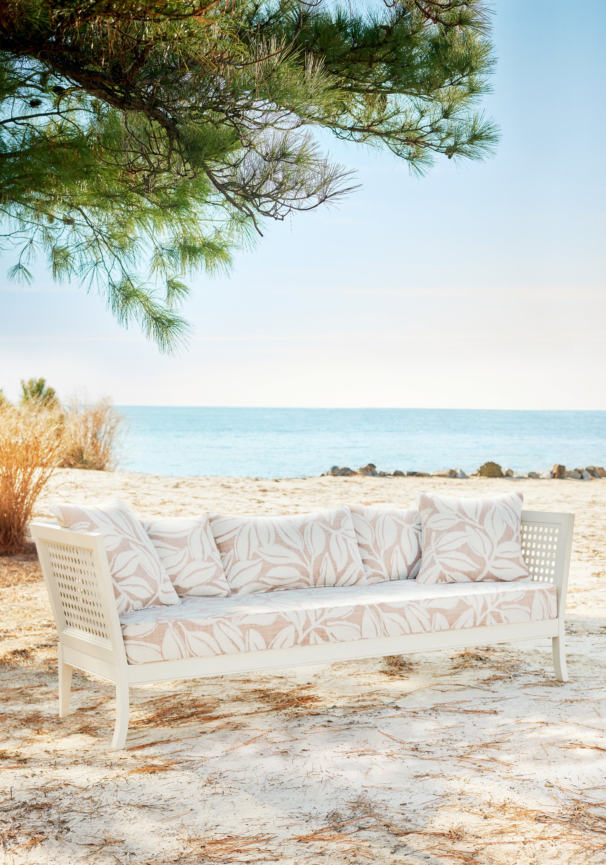 Pillows and sofa featuring Kona fabric in clay color - pattern number W8810 - by Thibaut in the Haven collection