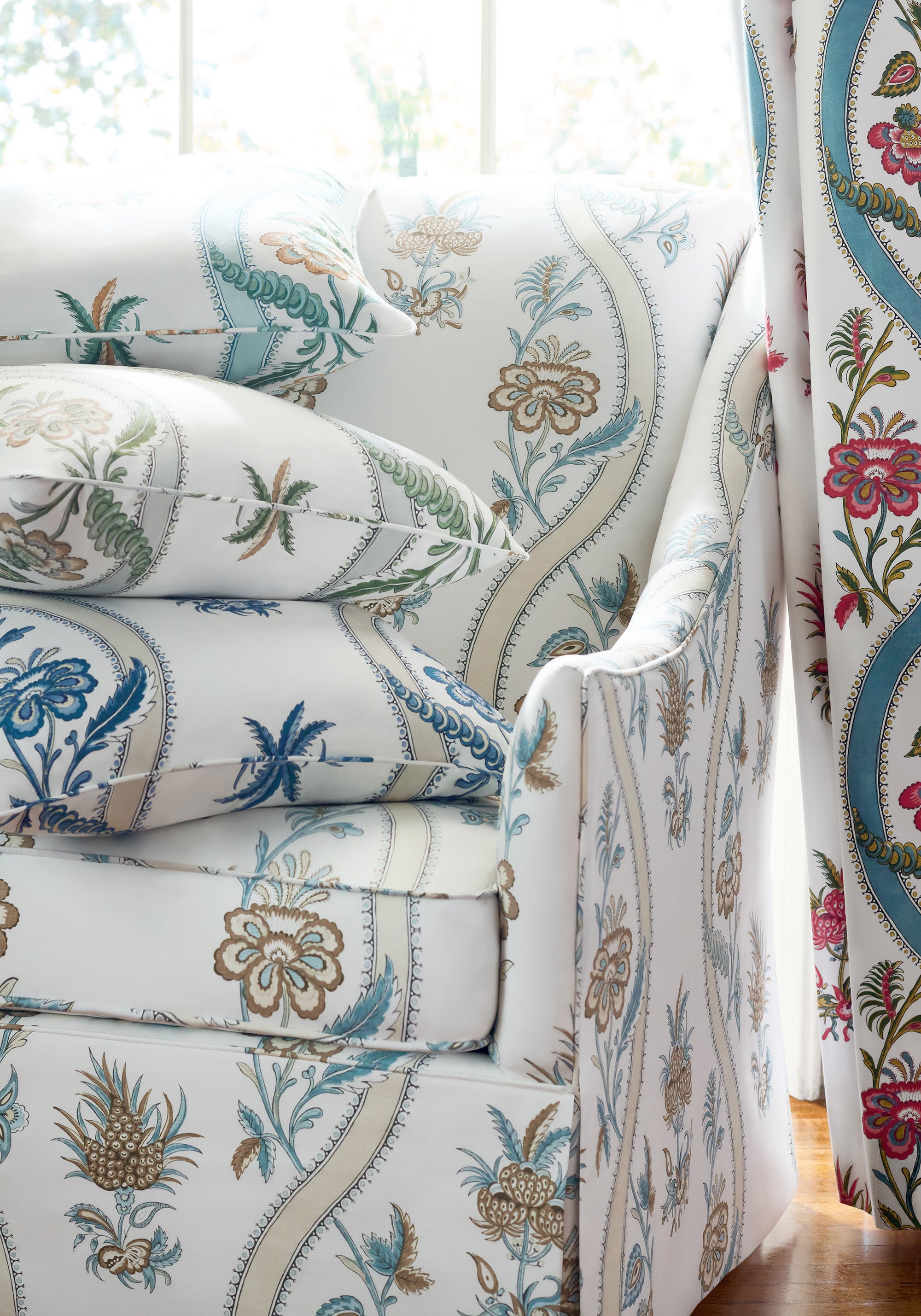 Close view of curtains featuring Ribbon Floral fabric in raspberry and teal color - pattern number F936426 - by Thibaut in the Indienne collection