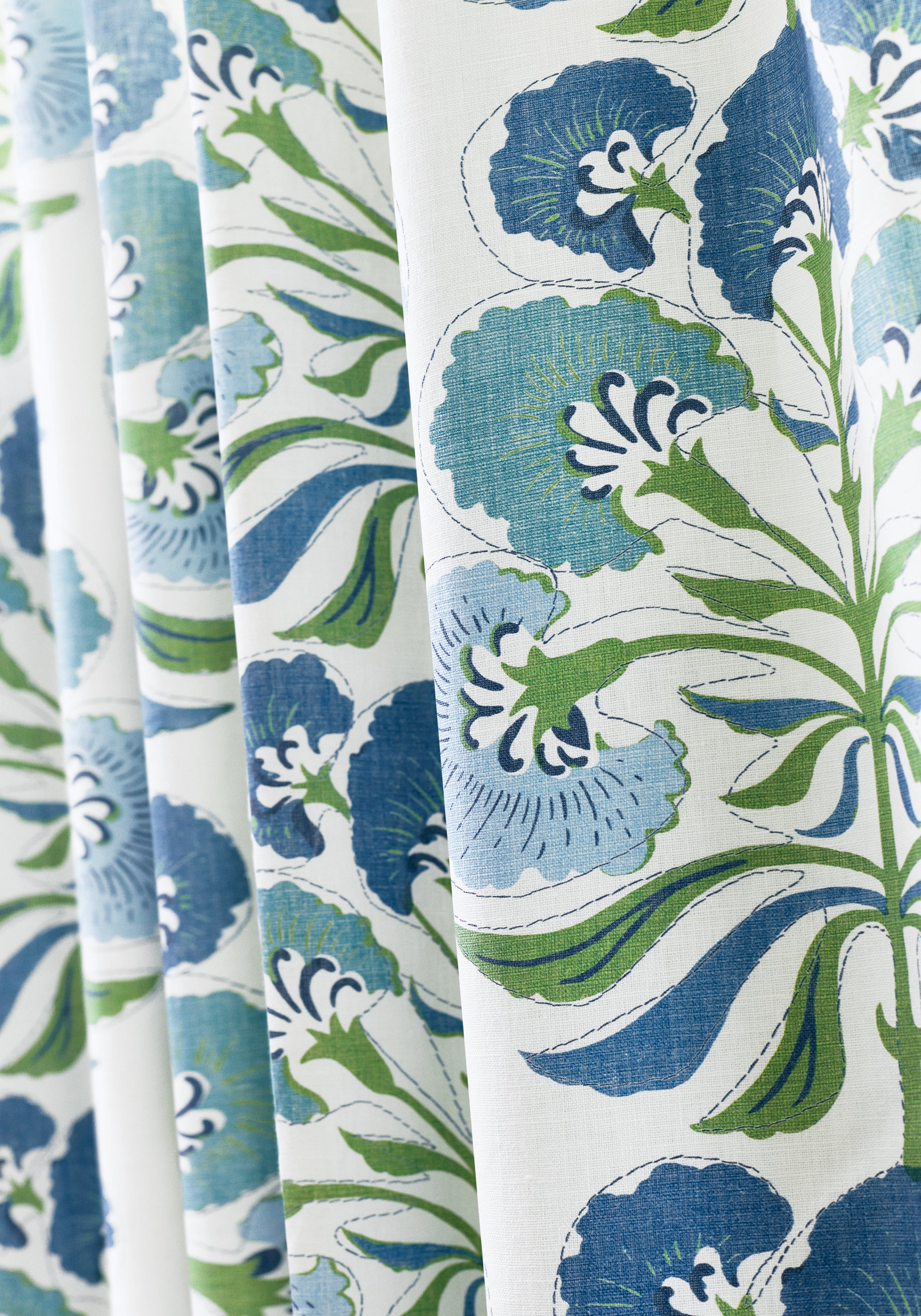 Close up of drapery curtains made with Tybee Tree fabric in green and blue color - pattern number F916215 - by Thibaut fabrics