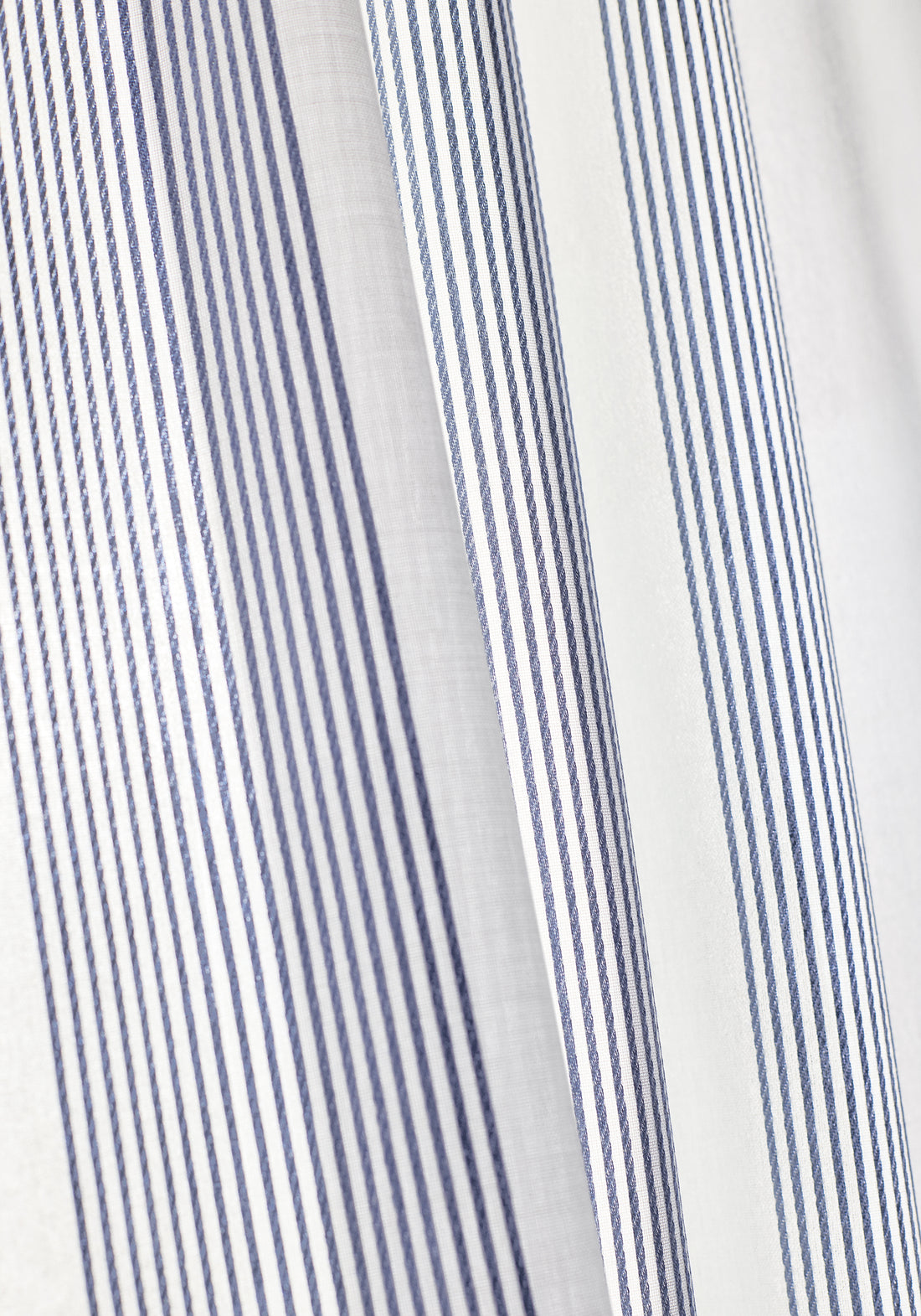 Closeup of curtains made with Sabine fabric in stripe oxford blue color - pattern number FWW81736 - by Thibaut fabrics