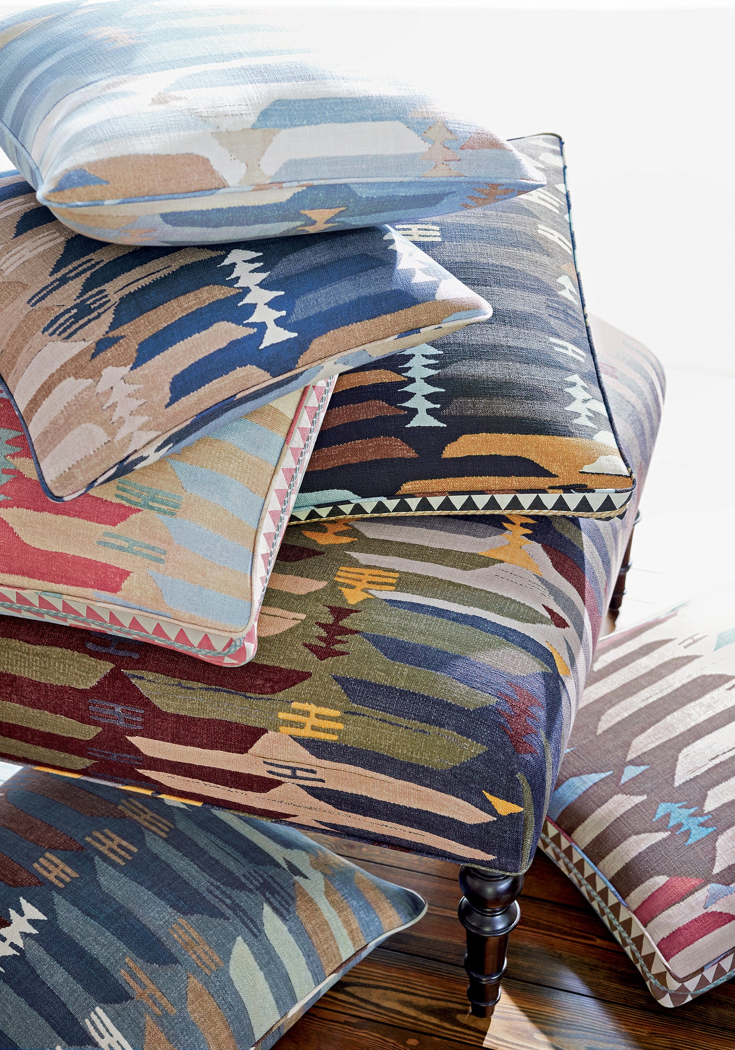 Baxter Ottoman and collection of Rio Grande printed fabric pillows featuring blue and beige color fabric - pattern number F913211 - by Thibaut in the Mesa collection