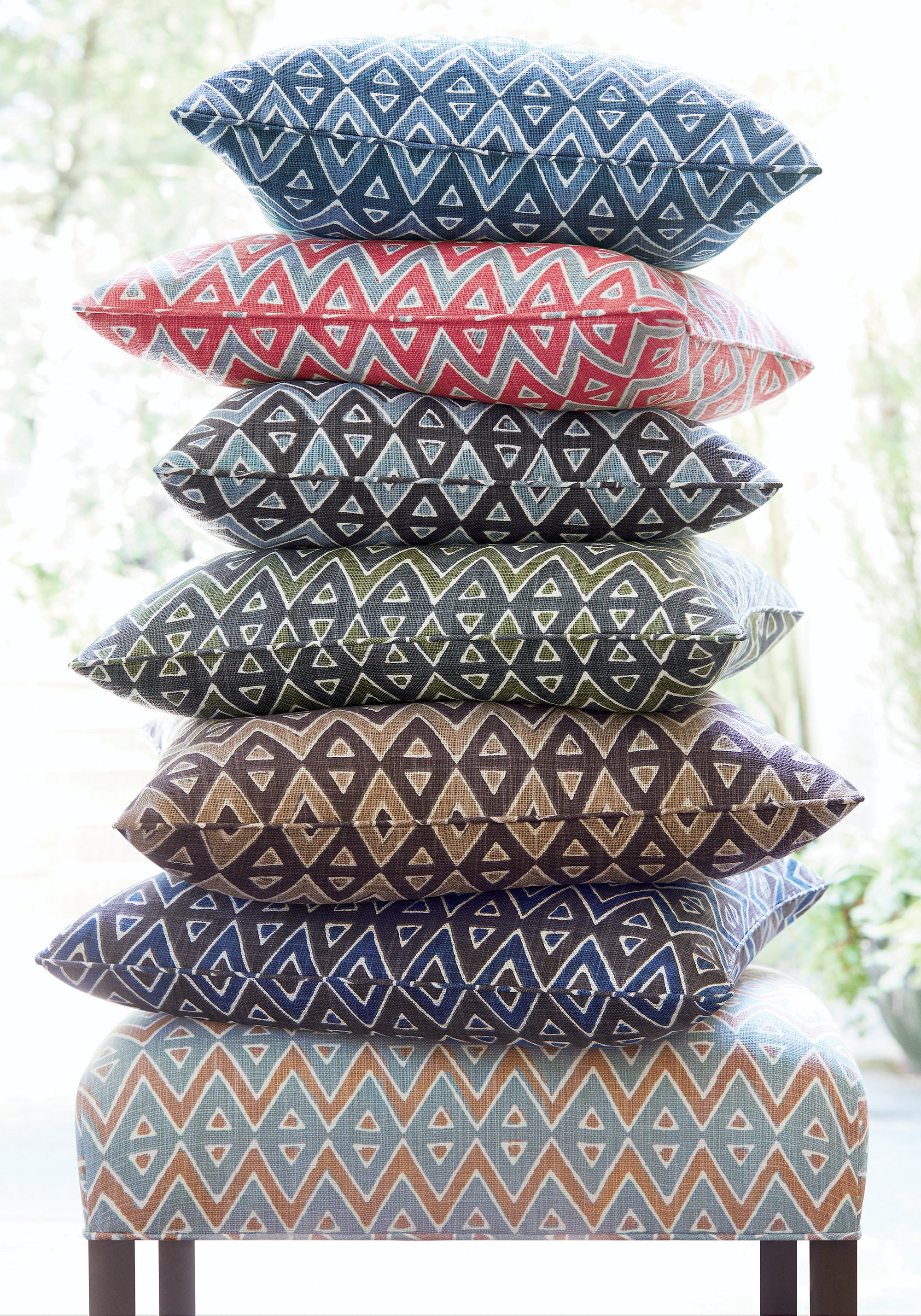 Bellwood Ottoman and collection of Tiburon printed fabric pillows featuring brown color fabric - pattern number F913239 - by Thibaut in the Mesa collection