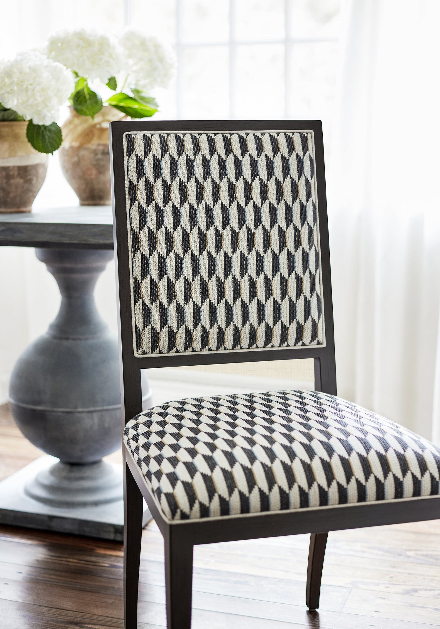Detailed view of Lauderdale Dining Chair in Optica woven fabric in charcoal color variant by Thibaut in the Nomad collection - pattern number W73353