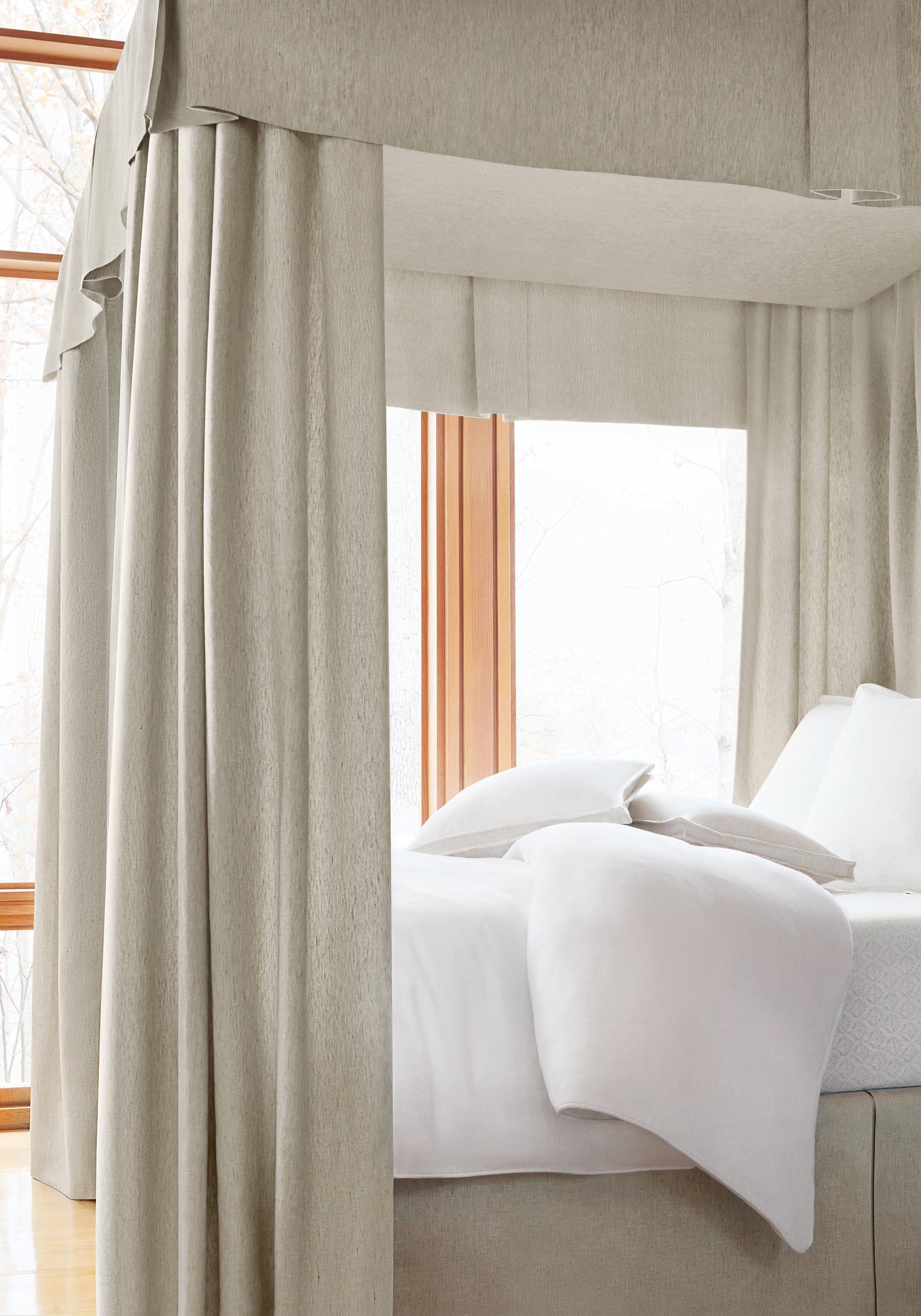 A bed canopy of Skye Linen wide woven fabric in stone color - pattern number FWW7601 - by Thibaut in the Palisades collection