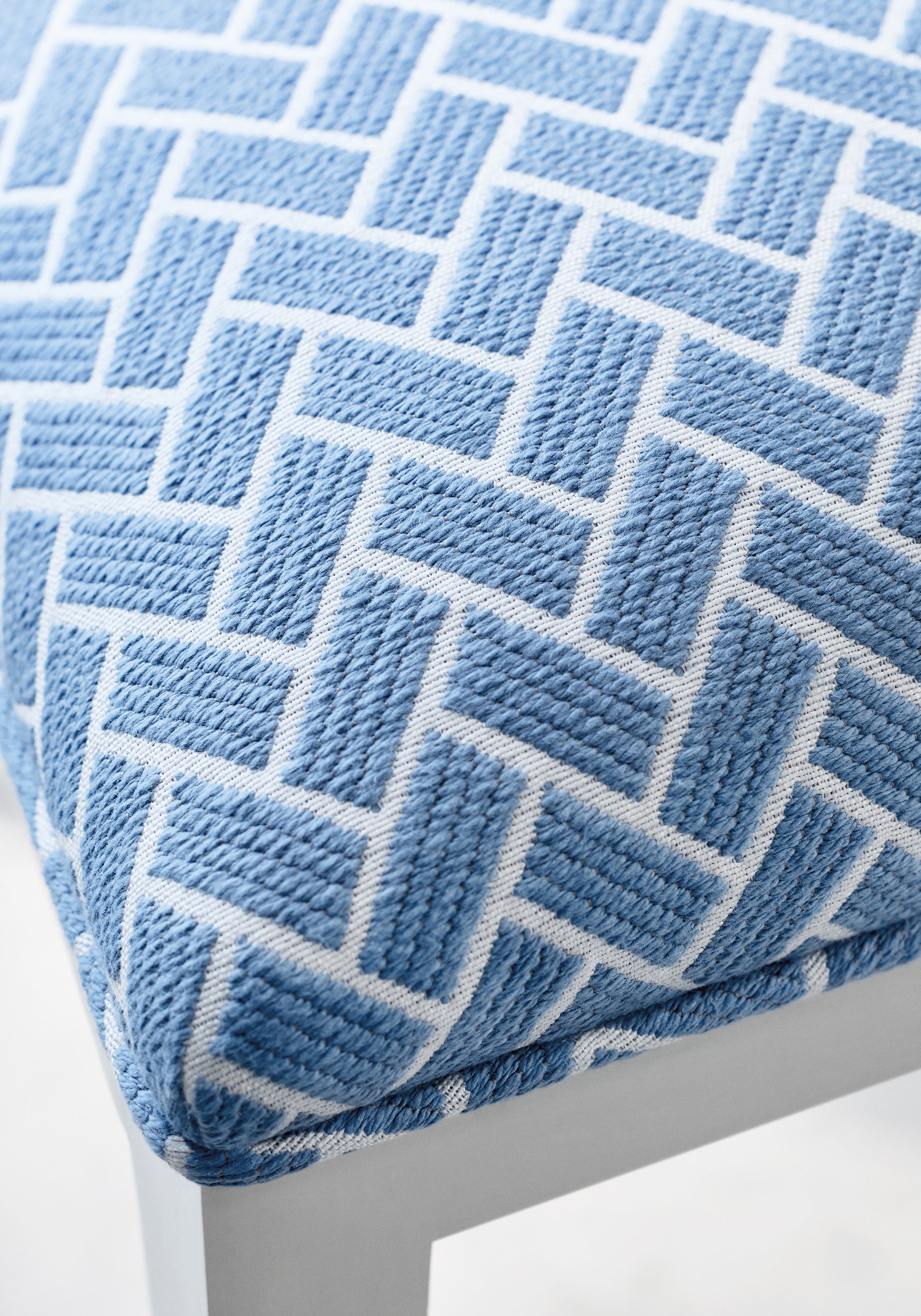 Detail of dining chair upholstered in Cobblestone fabric in cornflower color - pattern number W74221 - by Thibaut fabric