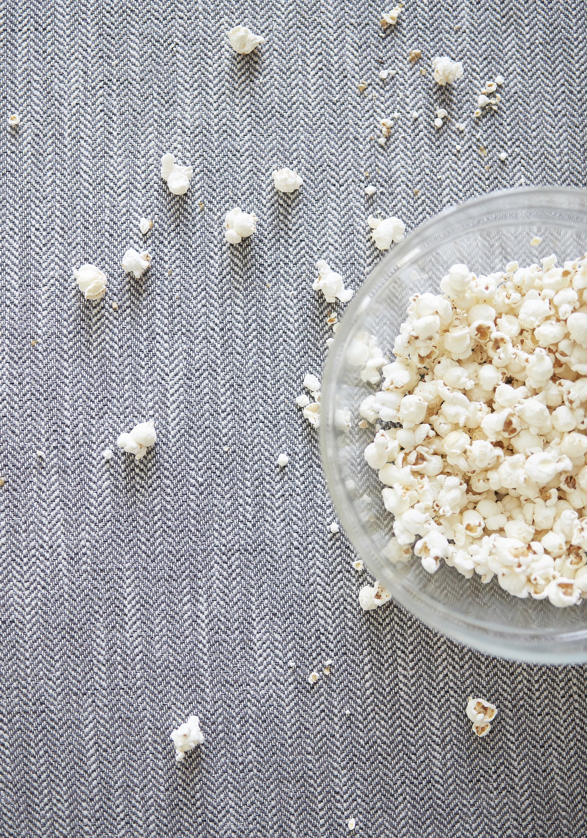 Popcorn grease and butter are no match for stain resistant Ashbourne Tweed woven fabric - pattern number W80618 in charcoal color by Thibaut in the Pinnacle collection