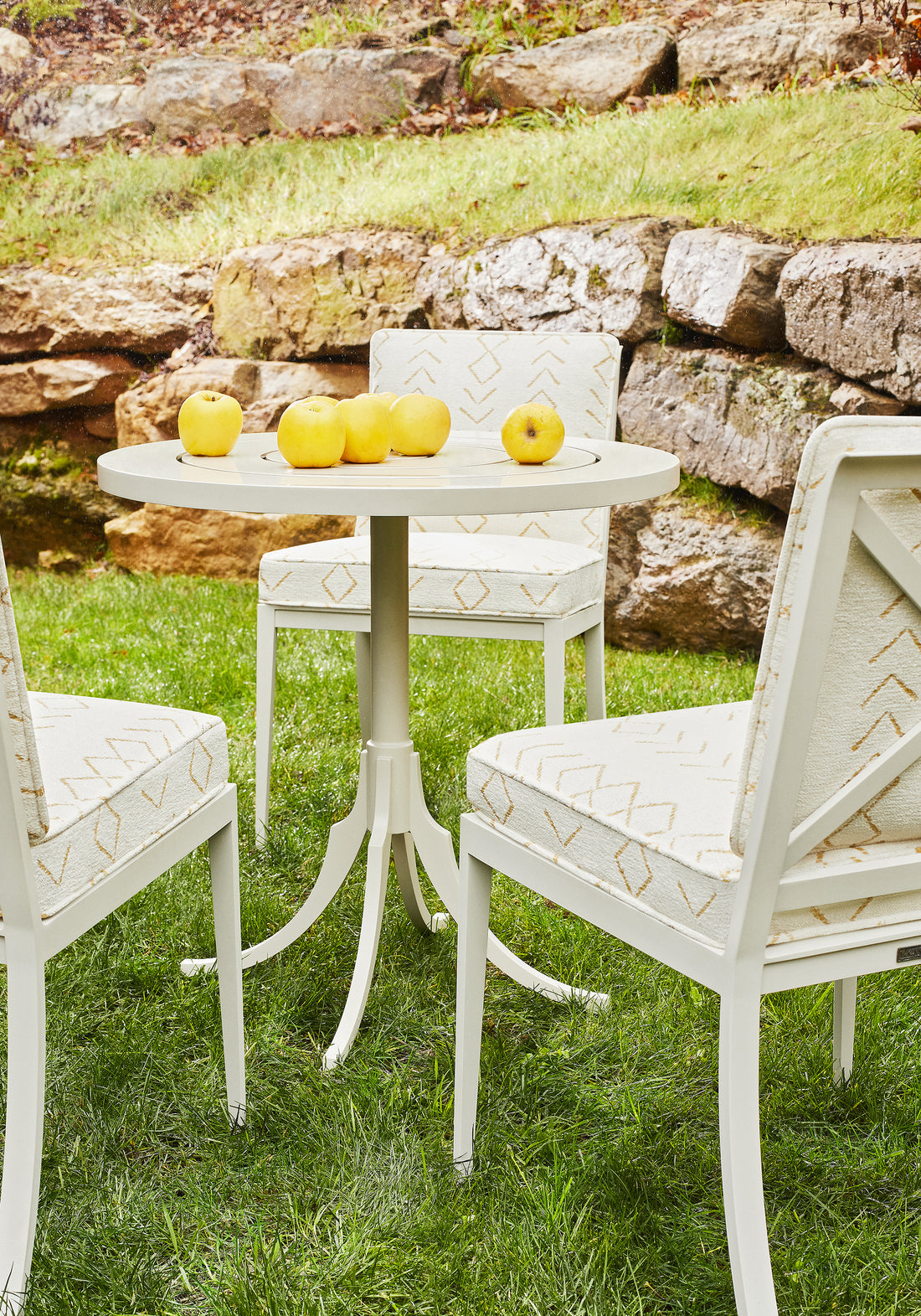 Outdoor chairs upholstered in Thibaut Anasazi woven fabric in Straw