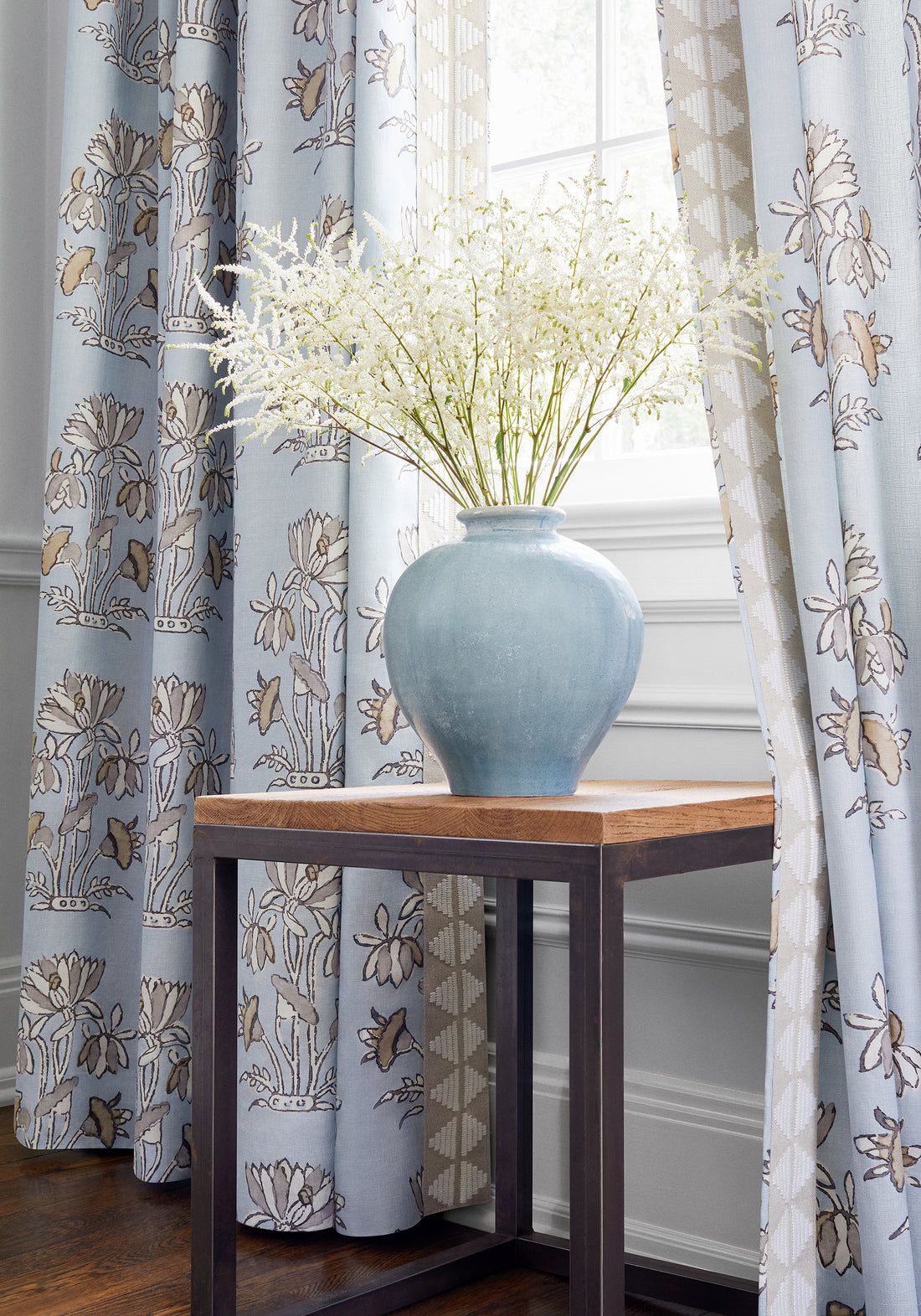 Draperies in Lily Flower printed fabric in spa blue with linen trim - pattern number F913201 - by Thibaut in the Mesa collection