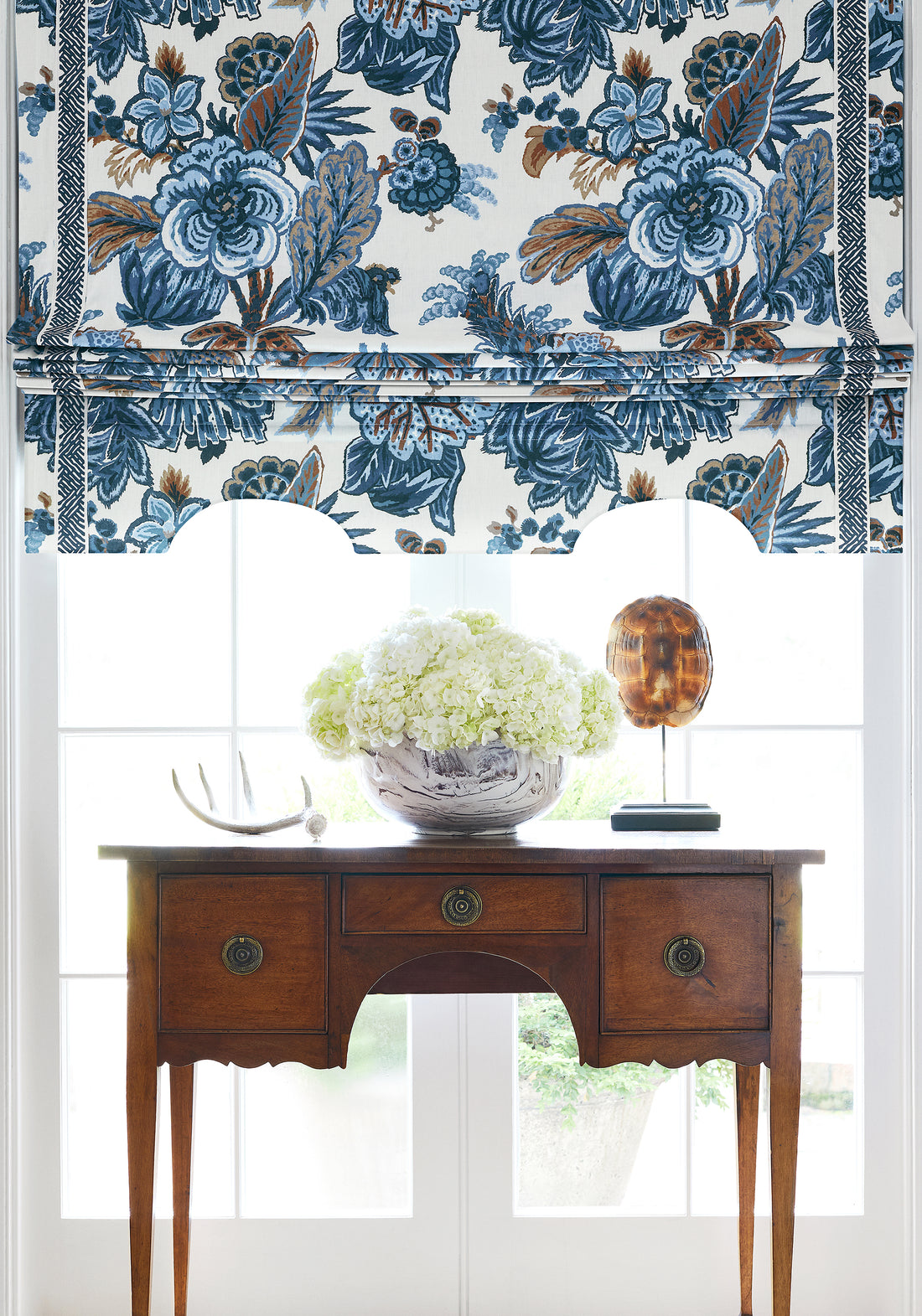 Roman shade in Floral Gala printed fabric in navy and white color - pattern number F910213 by Thibaut in the Colony collection