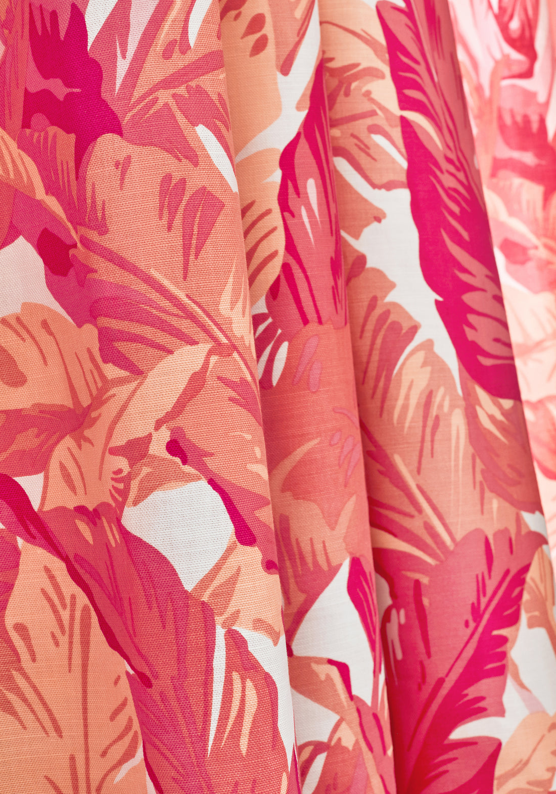 Detail of Travelers Palm printed fabric in pink and coral color of the Tropics collection by Thibaut - pattern number F910130