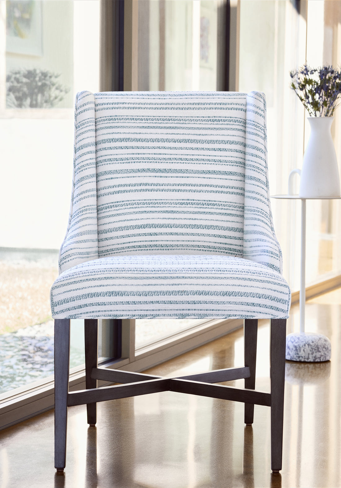 Frontal detailed view of Hayden Dining Chair in Bellano Stripe woven fabric in ocean color variant by Thibaut in the Veneto collection - pattern number W77152