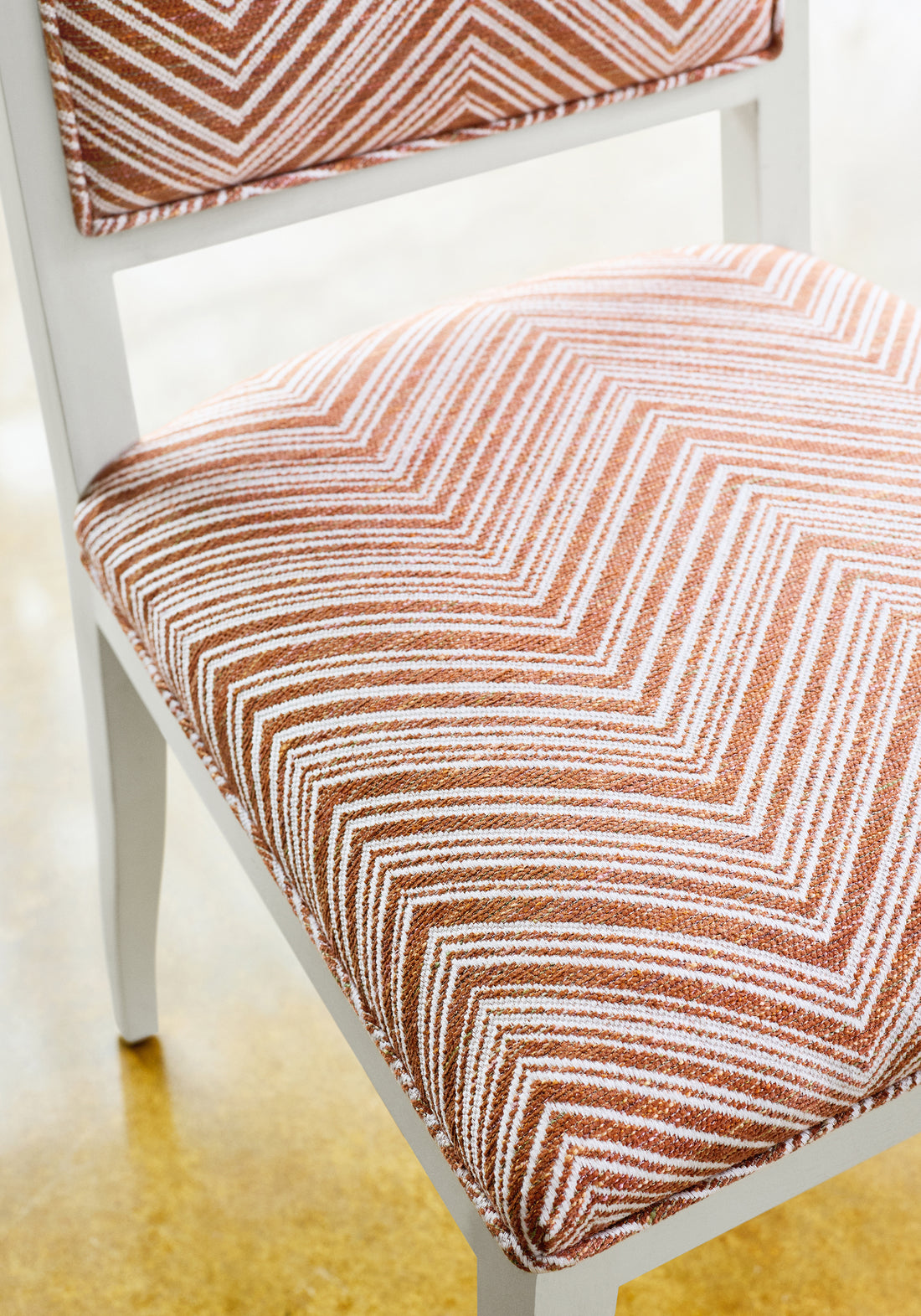 Frontal detailed view of Lauderdale Dining Chair in Monti Chevron woven fabric in copper color - pattern number W77138 - by Thibaut in the Veneto collection