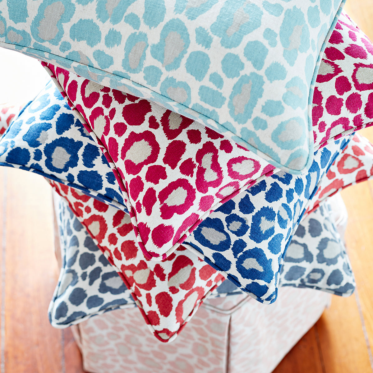 Pillow made with Anna French African Leopard printed fabric in coral - pattern number AF72979