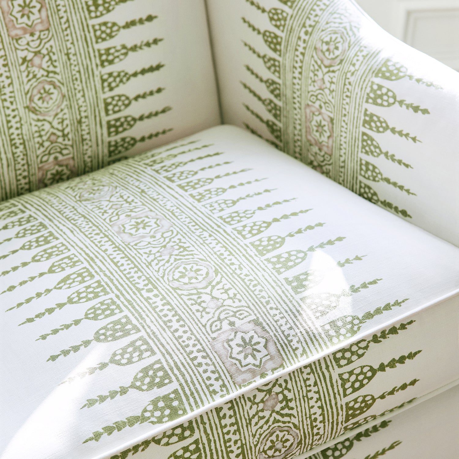 Detail of Shelton Wing Chair with Skirt in Javanese Stripe printed fabric in Green and White - pattern number AF15136 - by Anna French in the Antilles collection