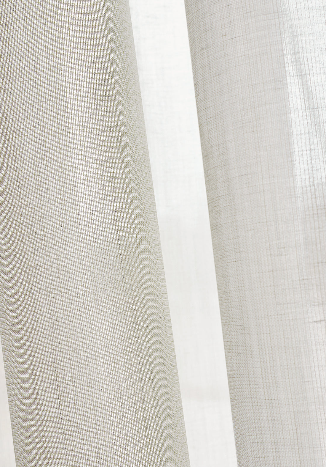 Closeup of sheer drapery curtains made with Thibaut Berkshire woven fabric in Ivory color pattern FWW7118