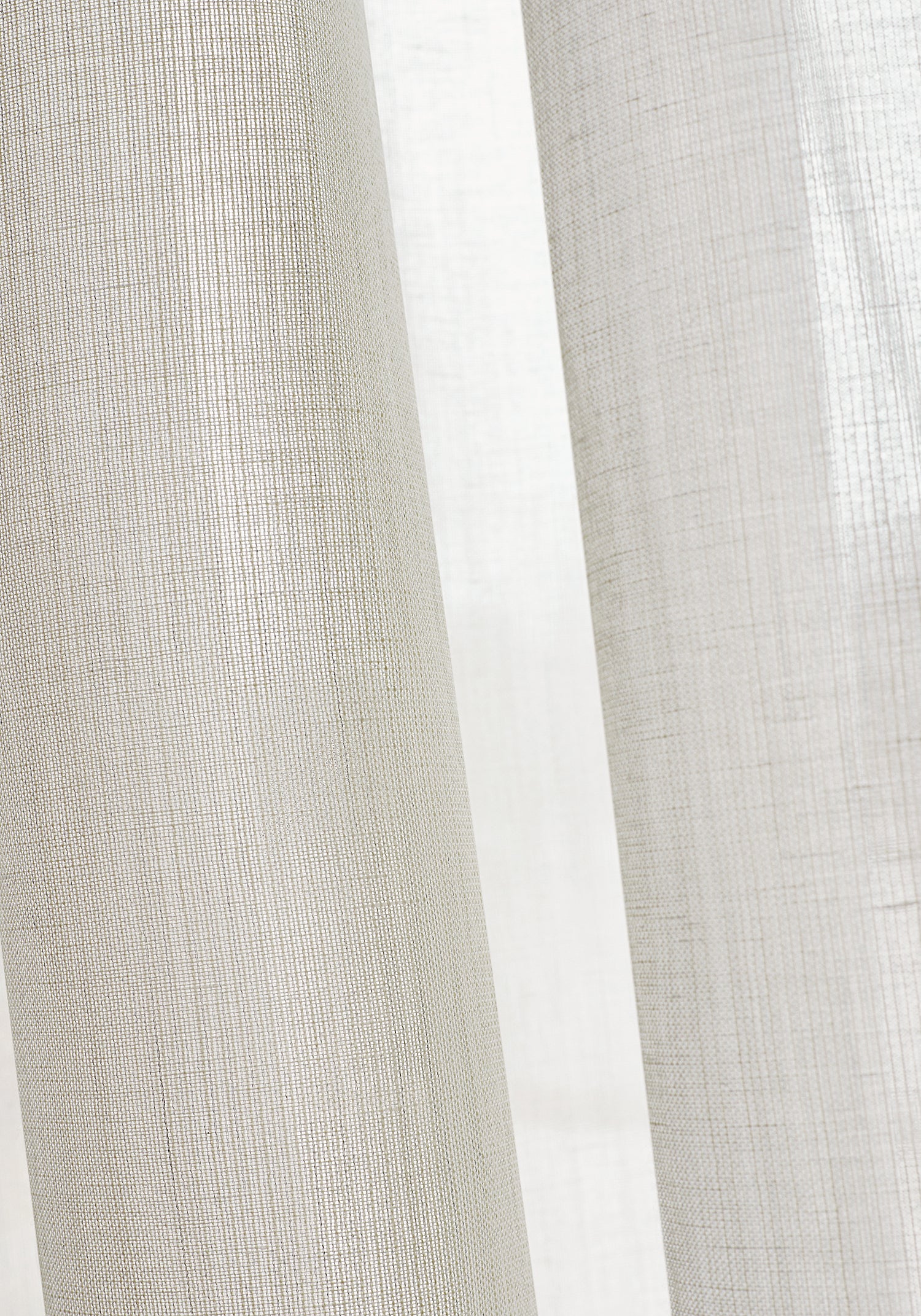 Closeup of sheer drapery curtains made with Thibaut Berkshire woven fabric in Ivory color pattern FWW7118