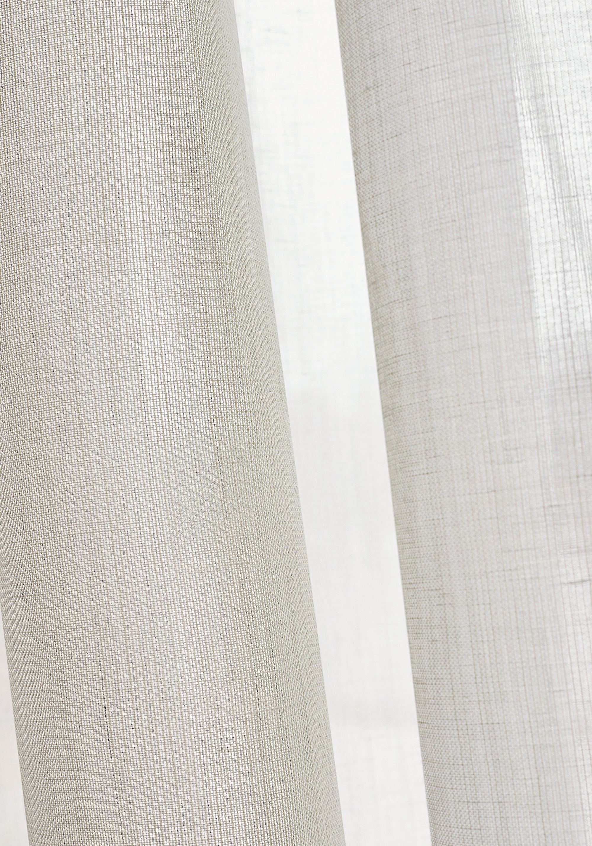 Closeup of sheer drapery curtains made with Thibaut Berkshire woven fabric in Ivory color pattern FWW7118