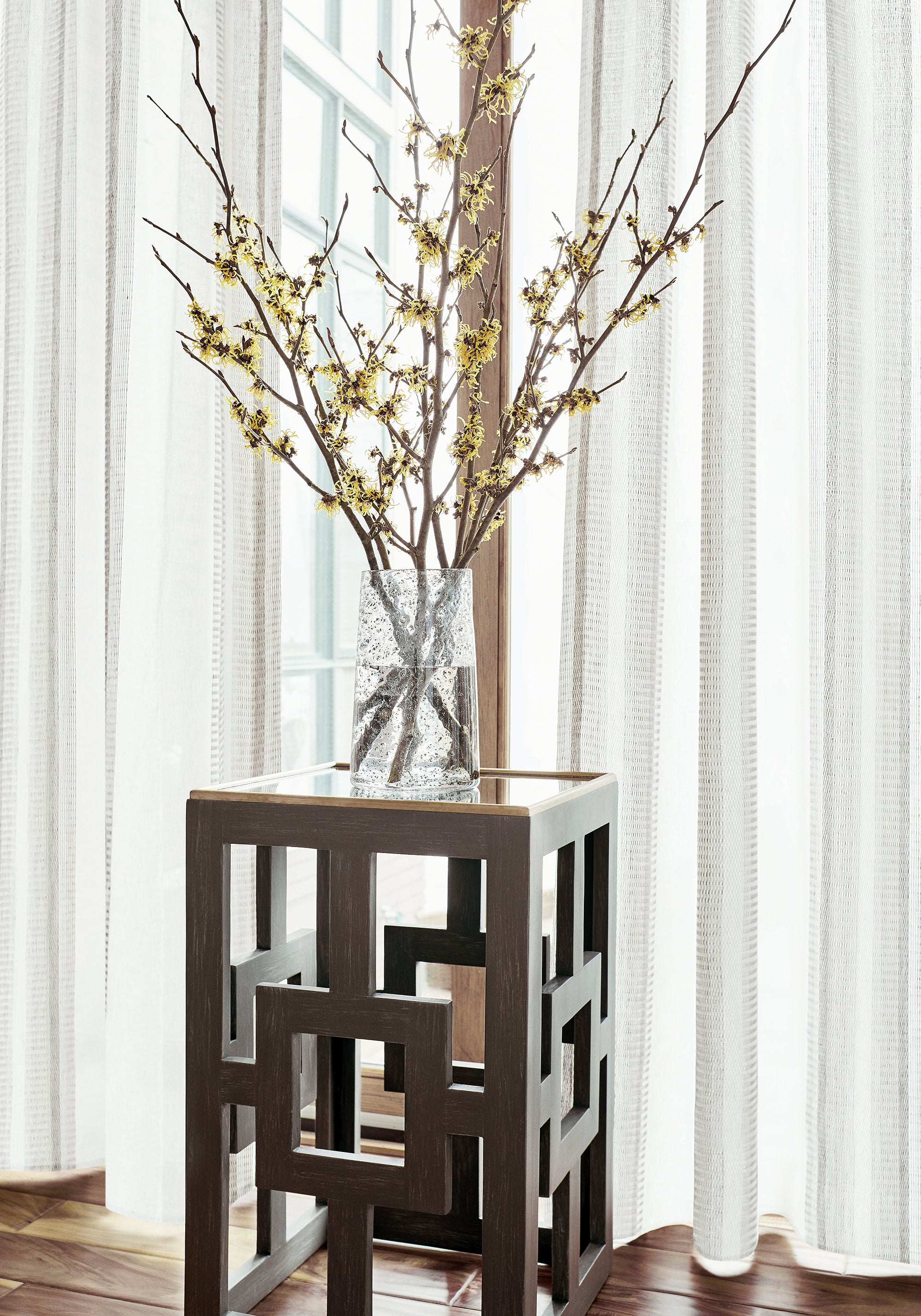 Living room with sheer curtains made from Thibaut Brampton Stripe woven fabric in Smoke color pattern FWW7163