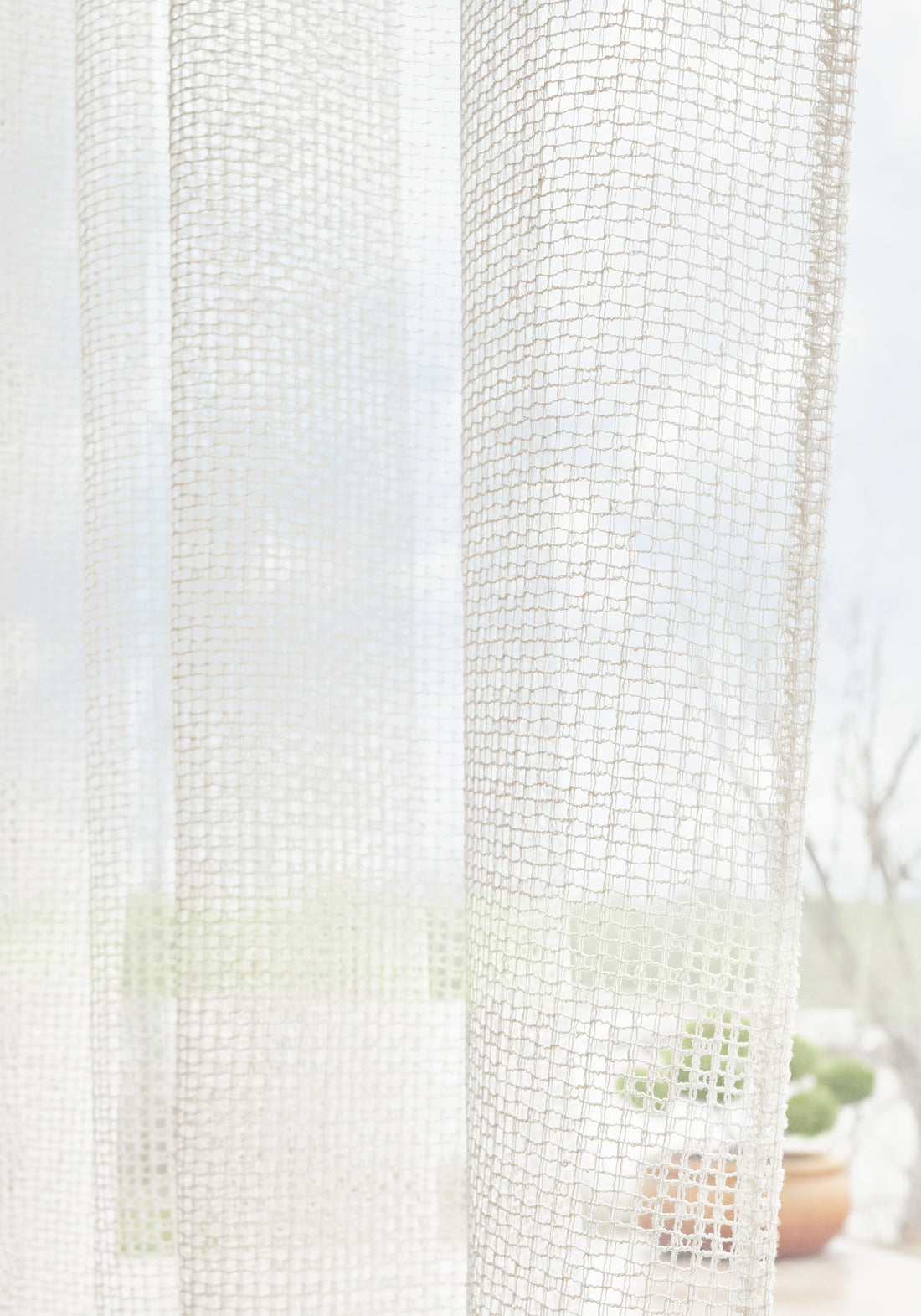 Sheer curtains made with Thibaut Carballo woven fabric in Ivory