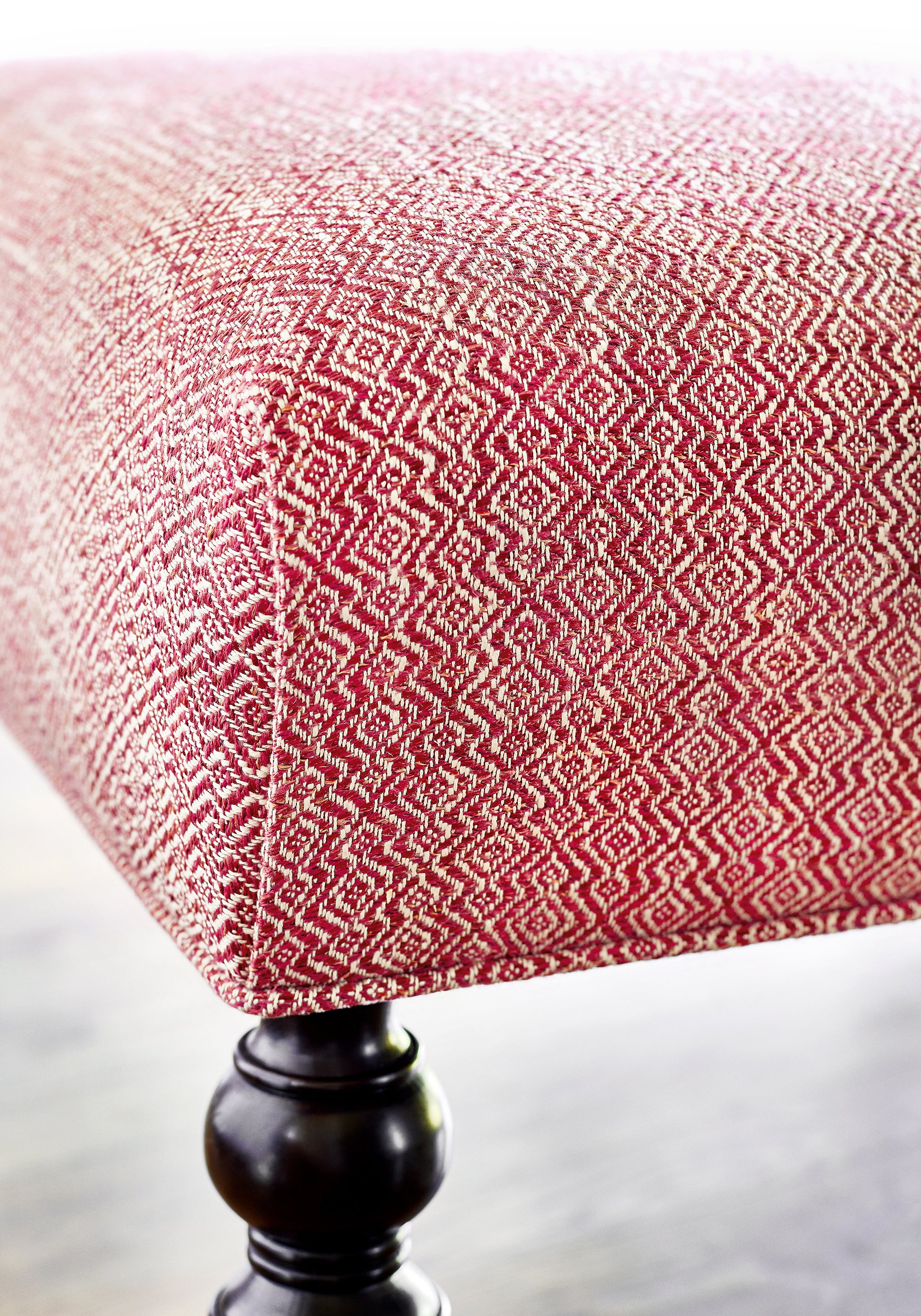 Close up detail of baxter ottoman made with Thibaut Kingsley woven fabric in Claret color - pattern number W74067 - in the Cadence collection
