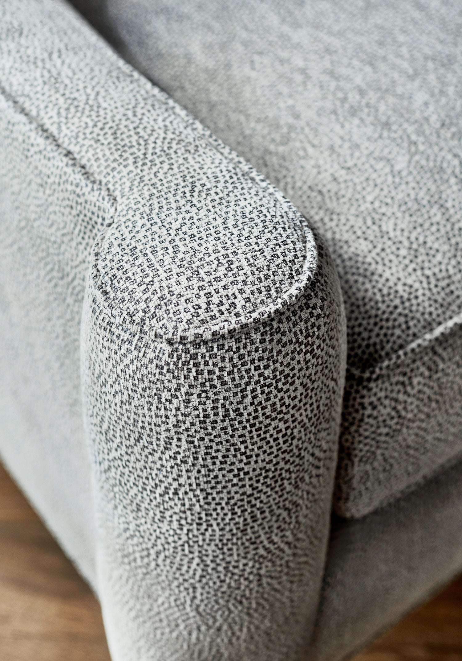 Closeup detail of Brighton sofa upholstered in Thibaut Nala woven fabric in Charcoal color - pattern W74081