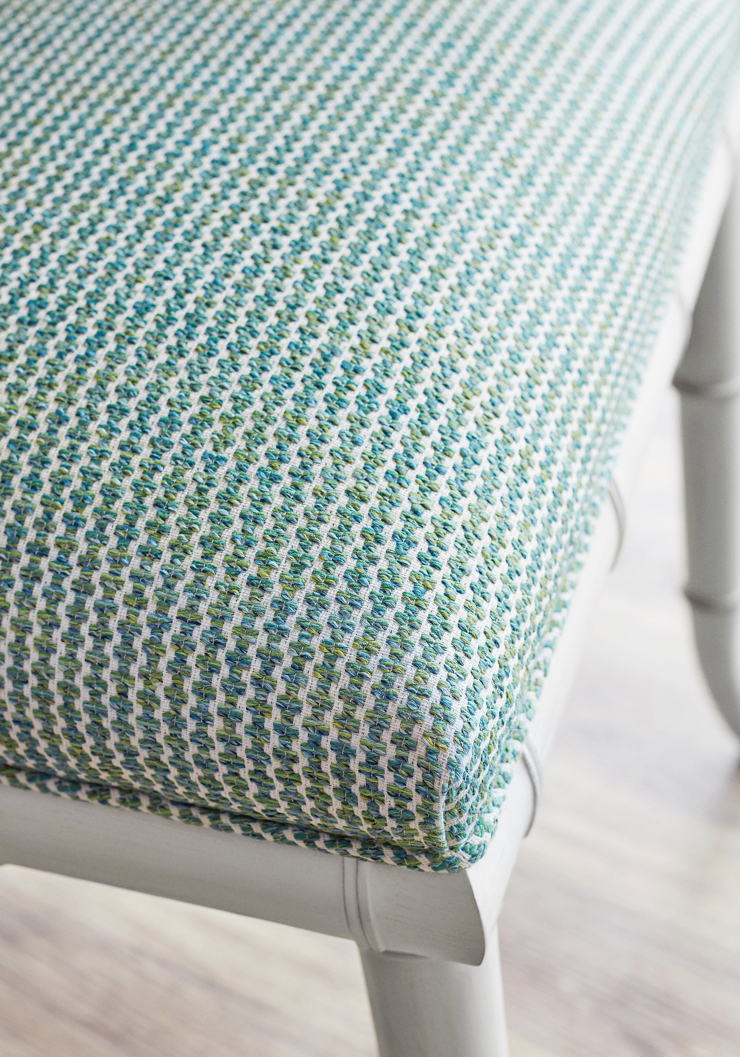 Closeup detail of Darien Dining Chairs upholstered in Thibaut Ryder woven fabric in Emerald color - pattern W74086