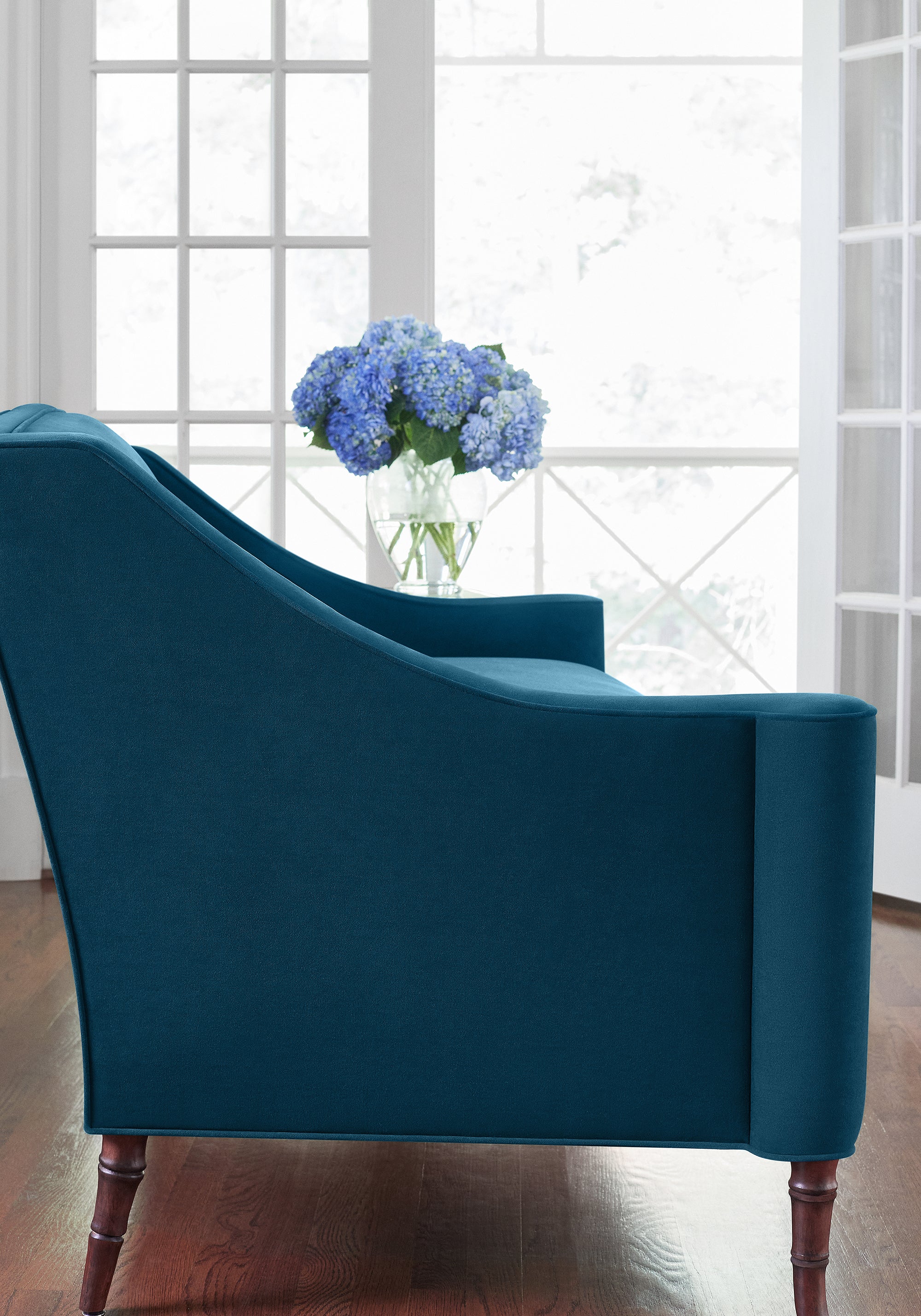 Side Detailed view of Brighton Settee in Club Velvet sustainable woven fabric in marine color variant by Thibaut in the Club Velvet collection - pattern number W7238