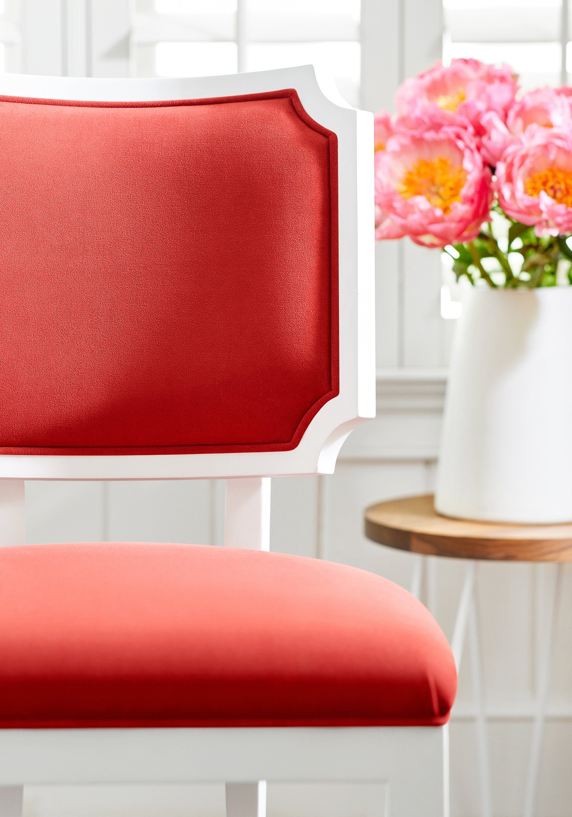 Detailed view of Kelby Dining Chair in Club Velvet sustainable woven fabric in coral color variant by Thibaut in the Club Velvet collection - pattern number W7204