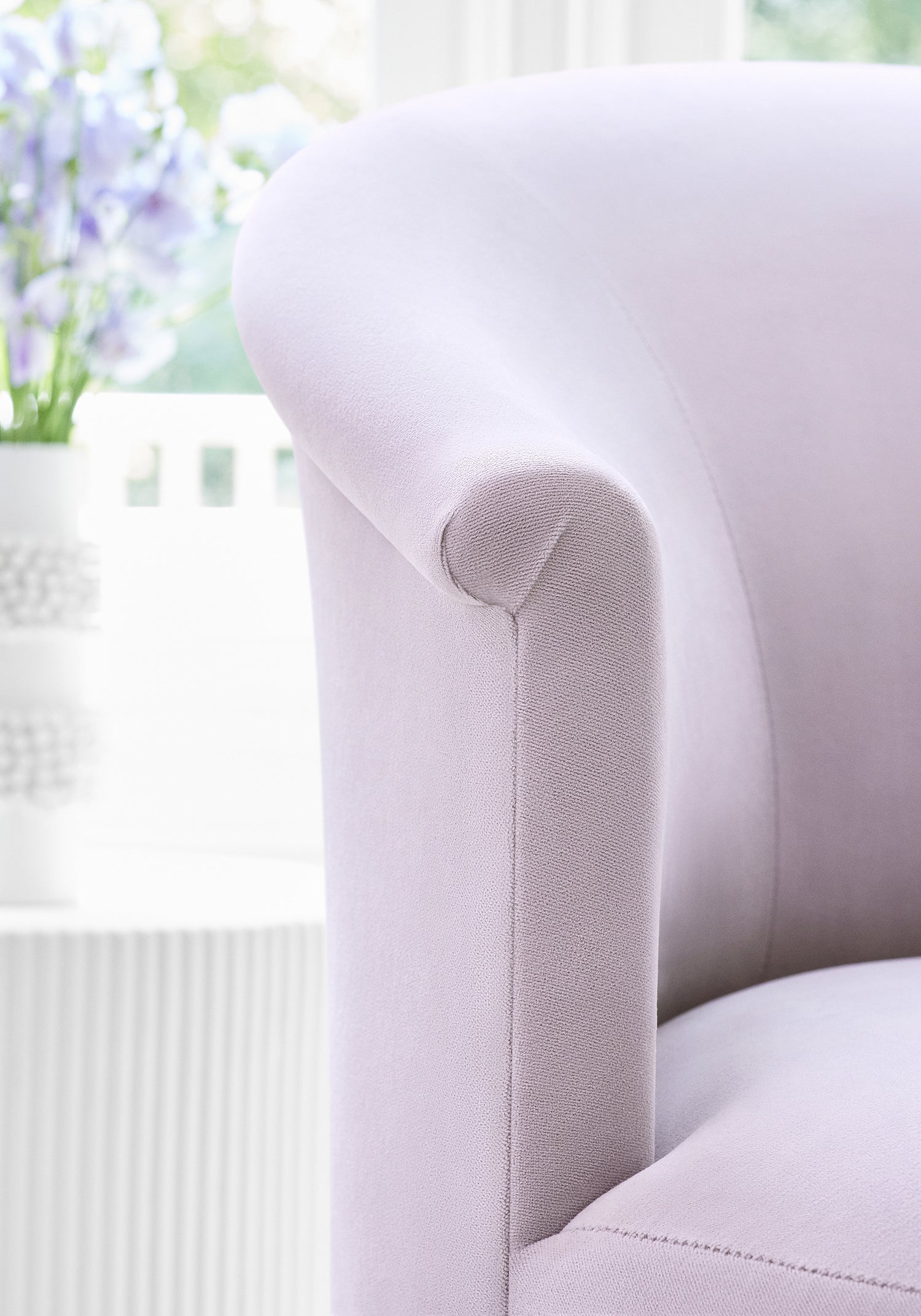 Detailed view of Ashby chair with Swivel in Club Velvet sustainable woven fabric in lilac color variant by Thibaut in the Club Velvet collection - pattern number W7214