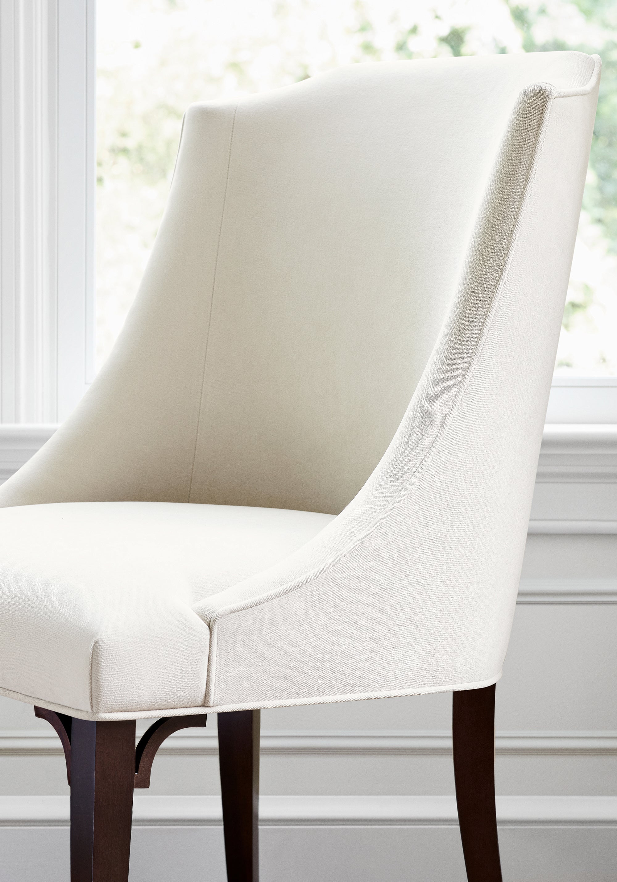 Detailed view of Bailey Dining chair in Club Velvet sustainable woven fabric in parchment color variant by Thibaut in the Club Velvet collection - pattern number W7232