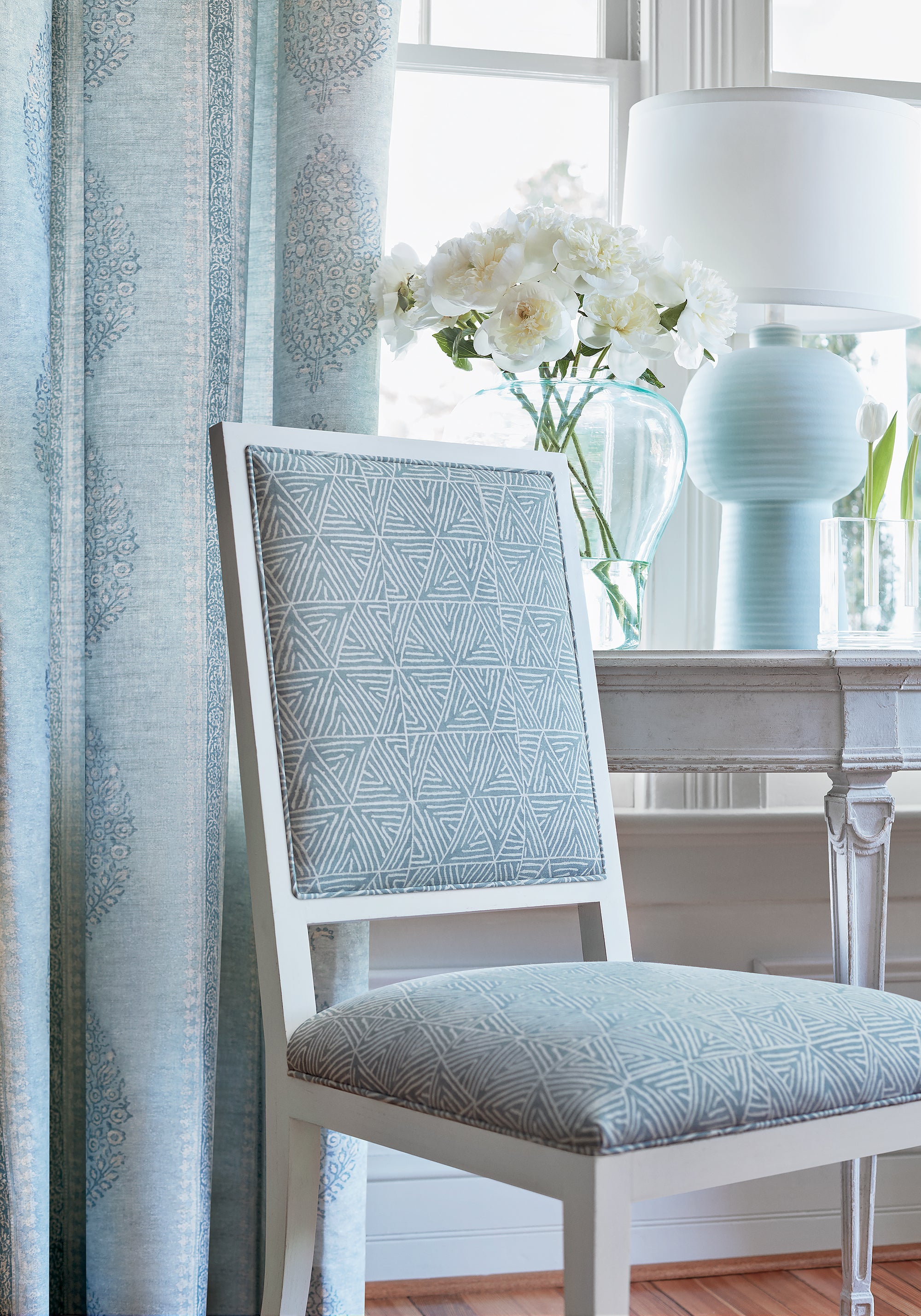 Detailed view of Lauderdale chairs in Mombasa printed fabric in slate blue color variant by Thibaut in the Colony collection - pattern number F910207