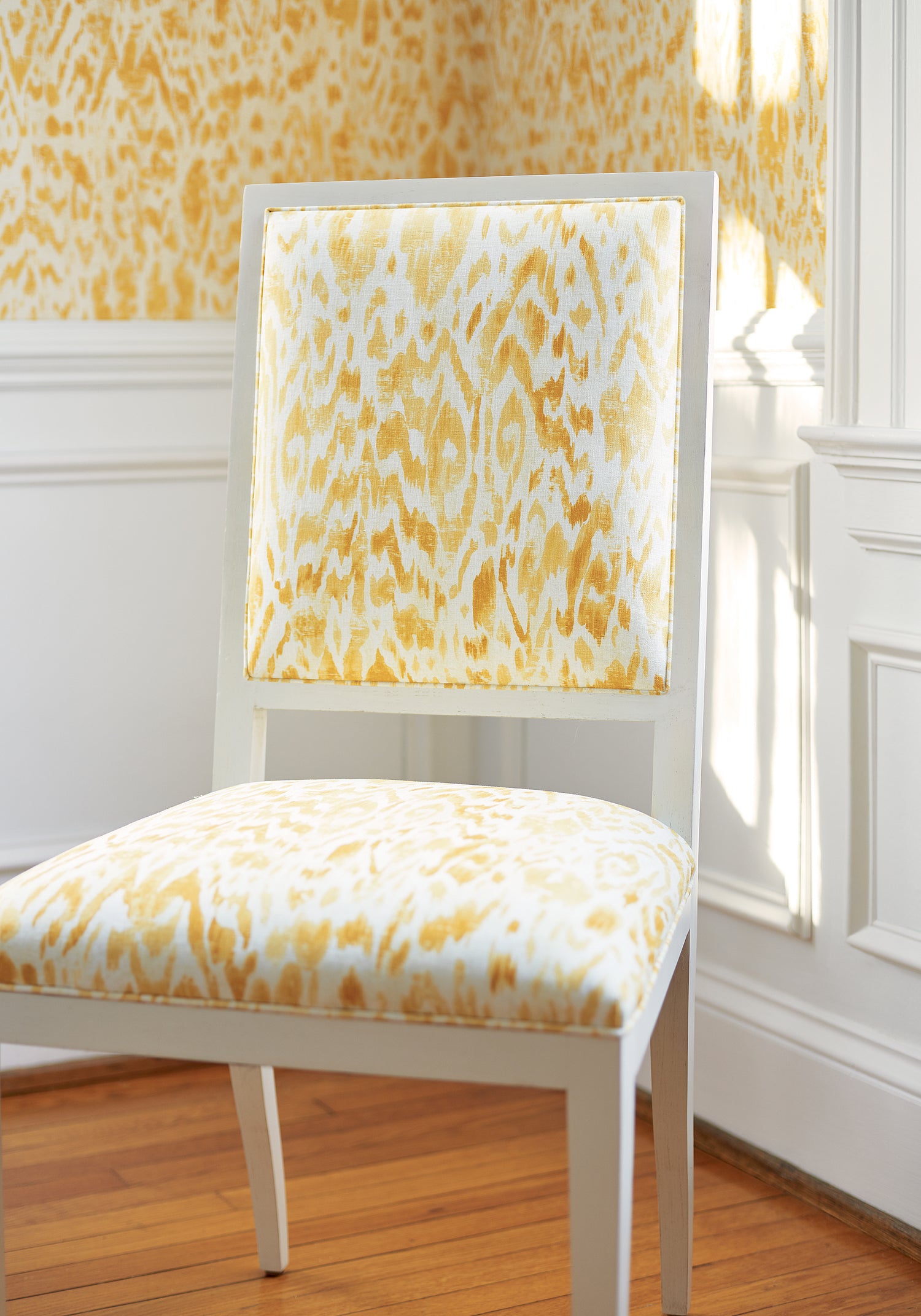 Detailed view of Lauderdale Dining Chair in Carlotta print fabric in yellow color variant by Thibaut in the Dynasty collection - pattern number F975457