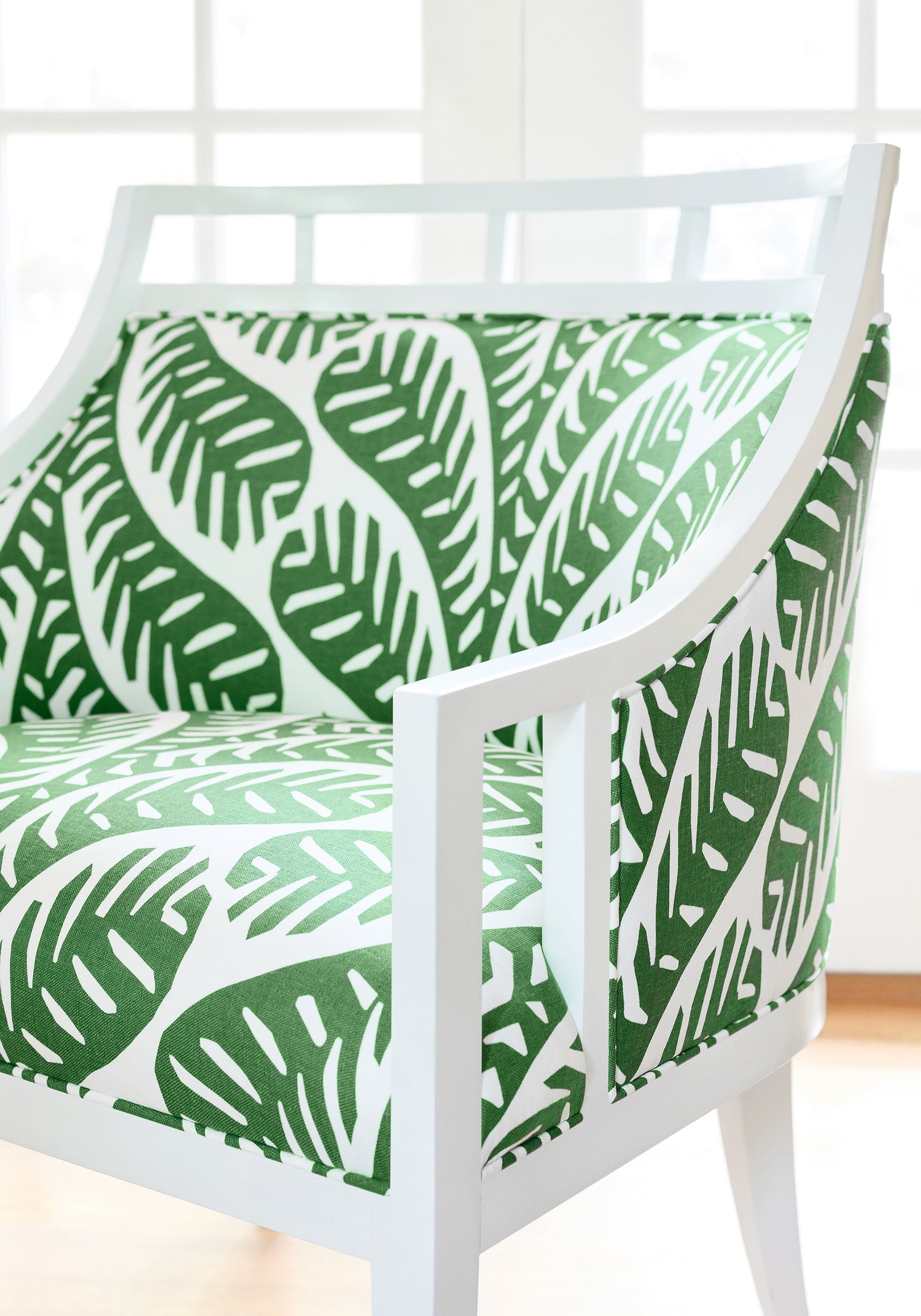 Detailed view of Malibu Chair in Ginger printed fabric in emerald color variant by Thibaut in the Eden collection - pattern number F920832