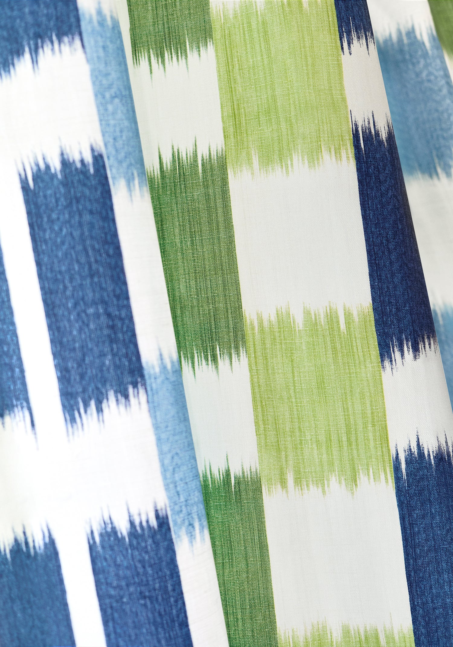 Detailed view of Draperies in Kasuri printed fabric in blue and green color variant by Thibaut in the Eden collection - pattern number F920839