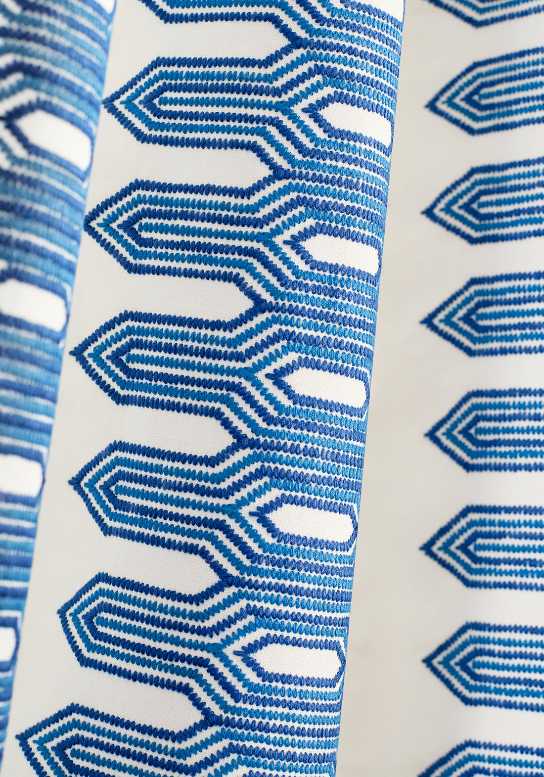 Detailed view of draperies in Nola Stripe Embroidery woven fabric in navy color variant by Thibaut in the Eden collection - pattern number W720810