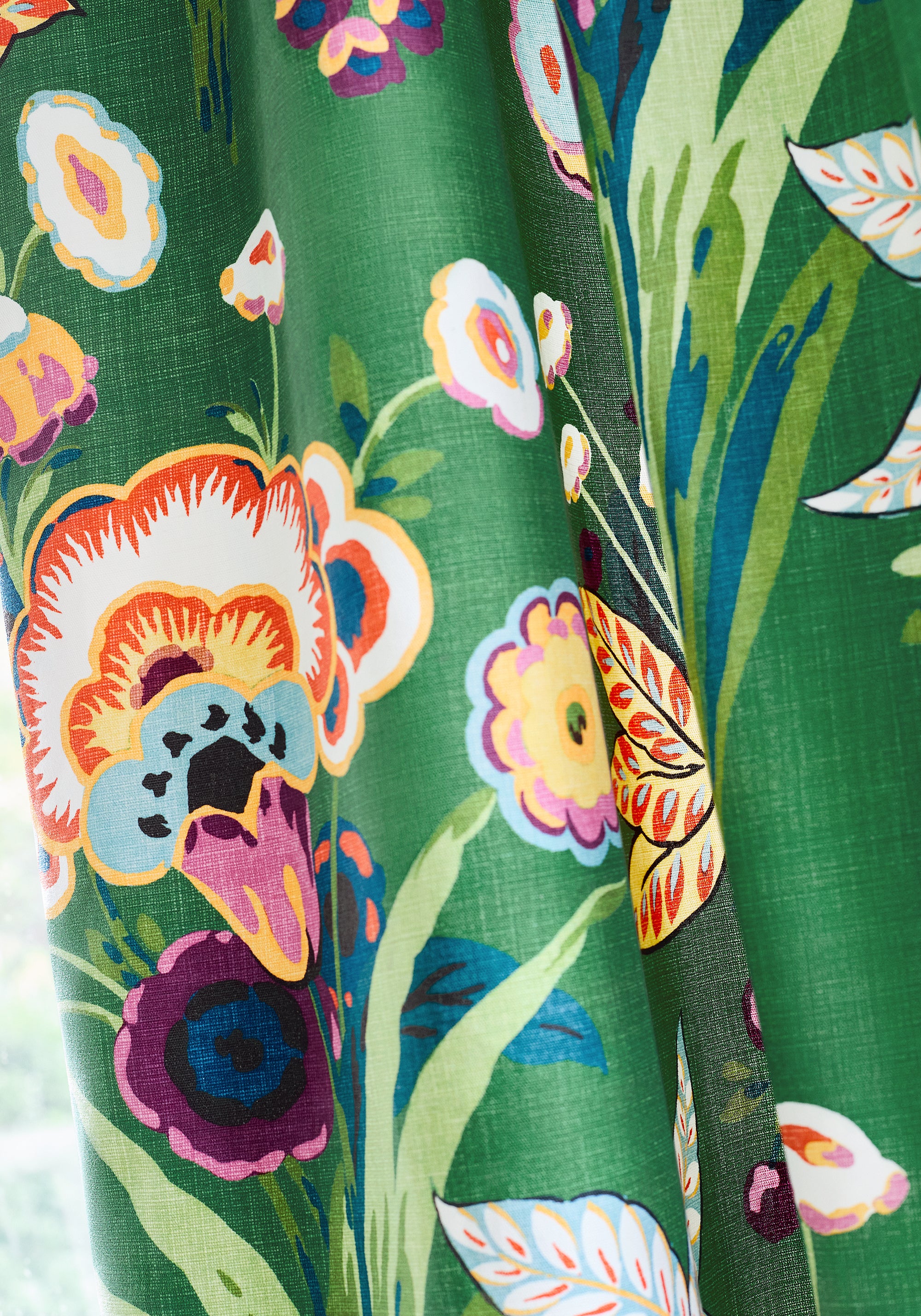 Detailed view of draperies in Pasadena printed fabric in emerald color variant by Thibaut in the Eden collection - pattern number F920849