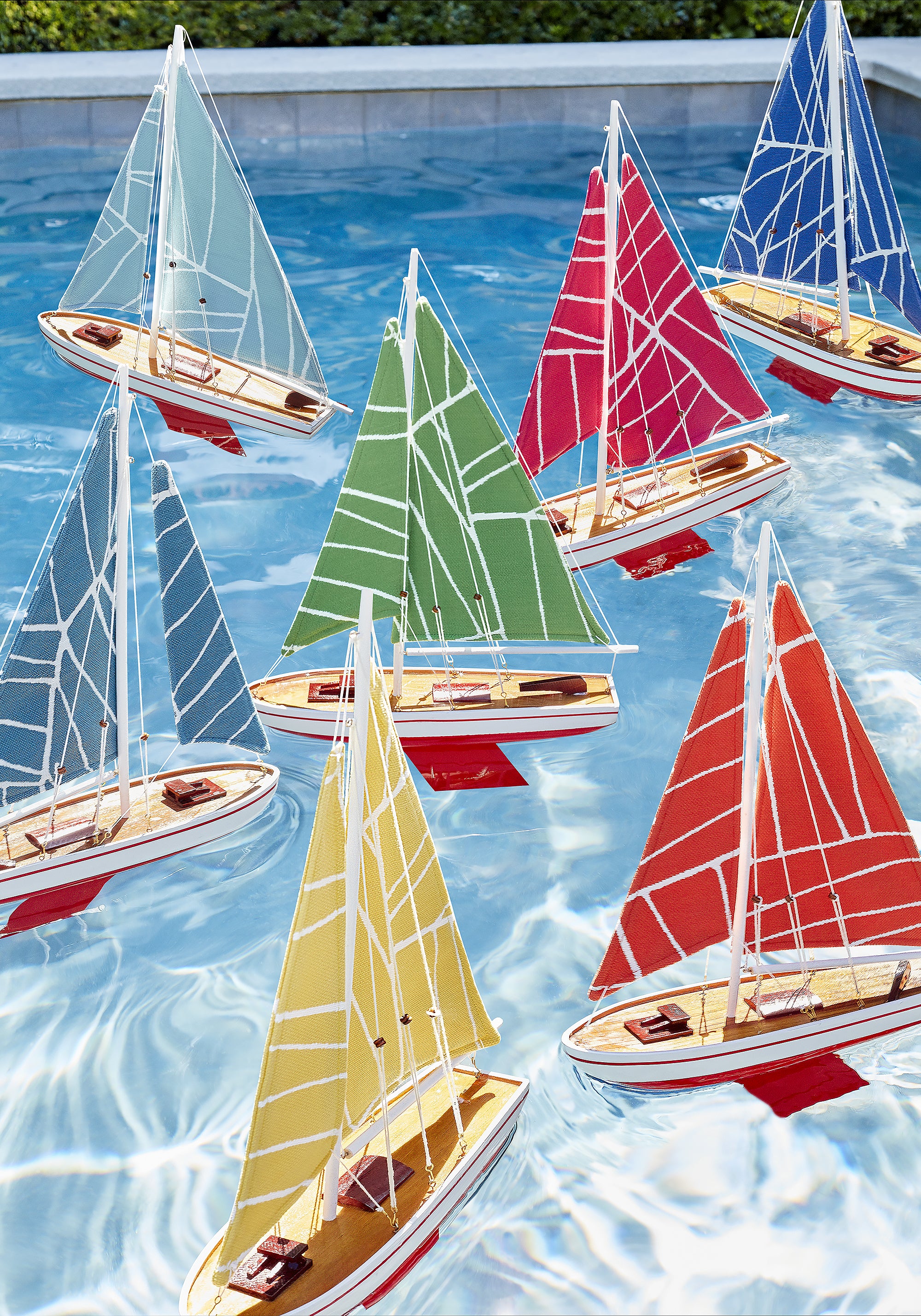 Collection of fabrics as toy boat sails in Jordan woven stain resistant fabric in featuring coral color fabric - pattern number W74650 - by Thibaut in the Festival collection