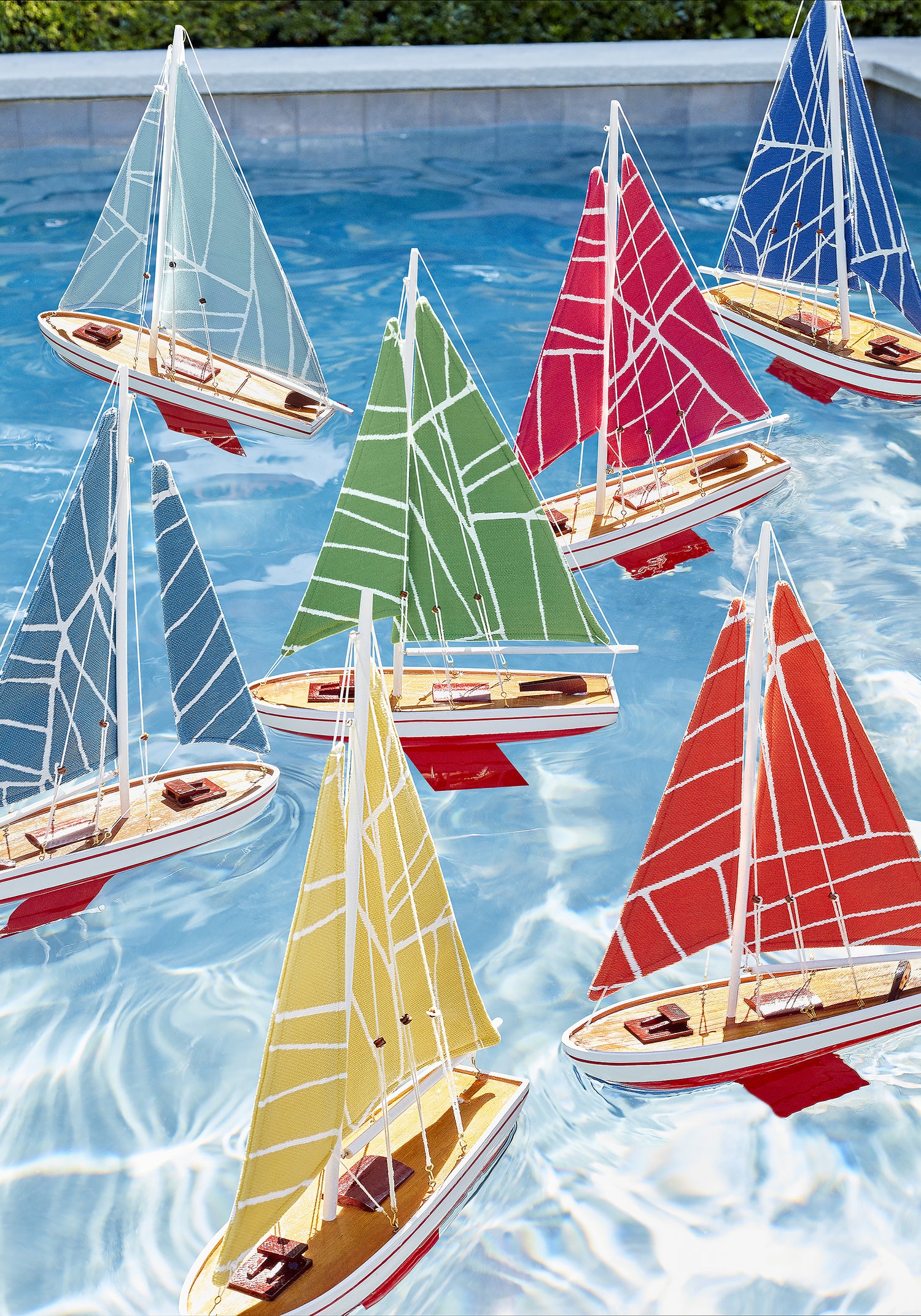 Collection of fabrics as toy boat sails in Jordan woven stain resistant fabric in featuring magenta color fabric - pattern number W74649 - by Thibaut in the Festival collection