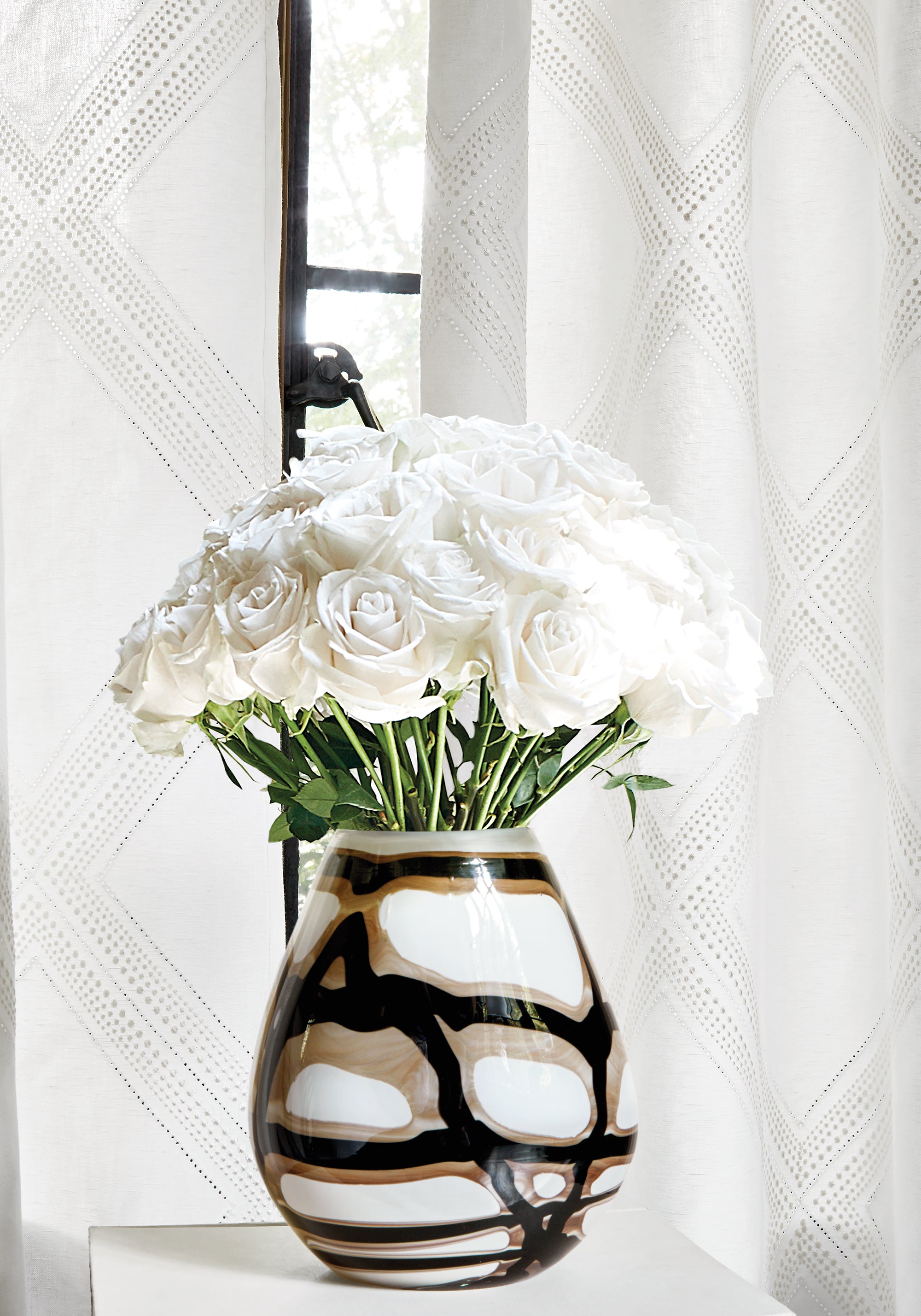 Close view of curtains featuring Diamond Head Embroidery fabric in white color - pattern number W785013 - by Thibaut in the Greenwood collection