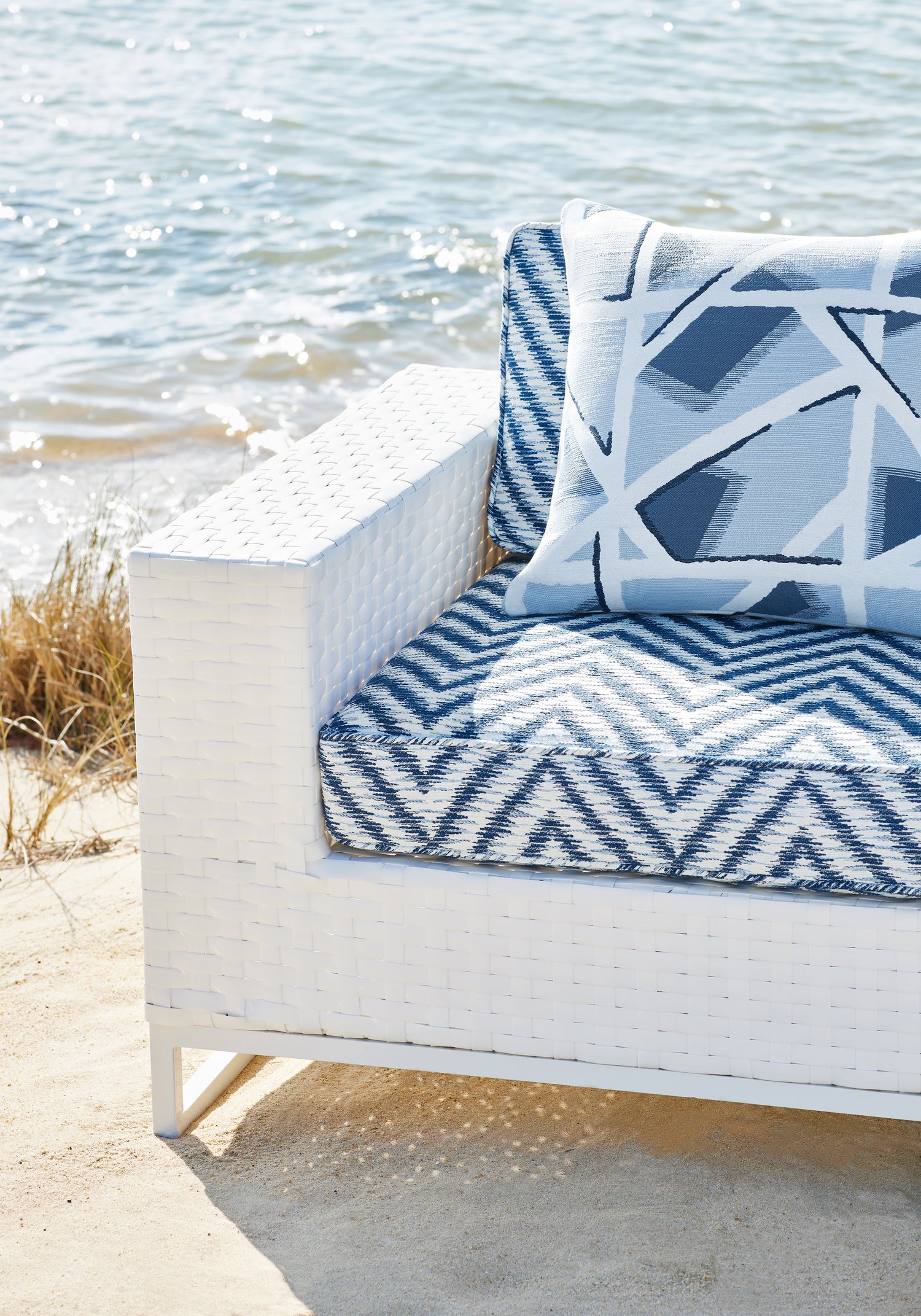 Close view of outdoor chair cushion featuring Aliso fabric in navy color - pattern number W8819 - by Thibaut in the Haven collection